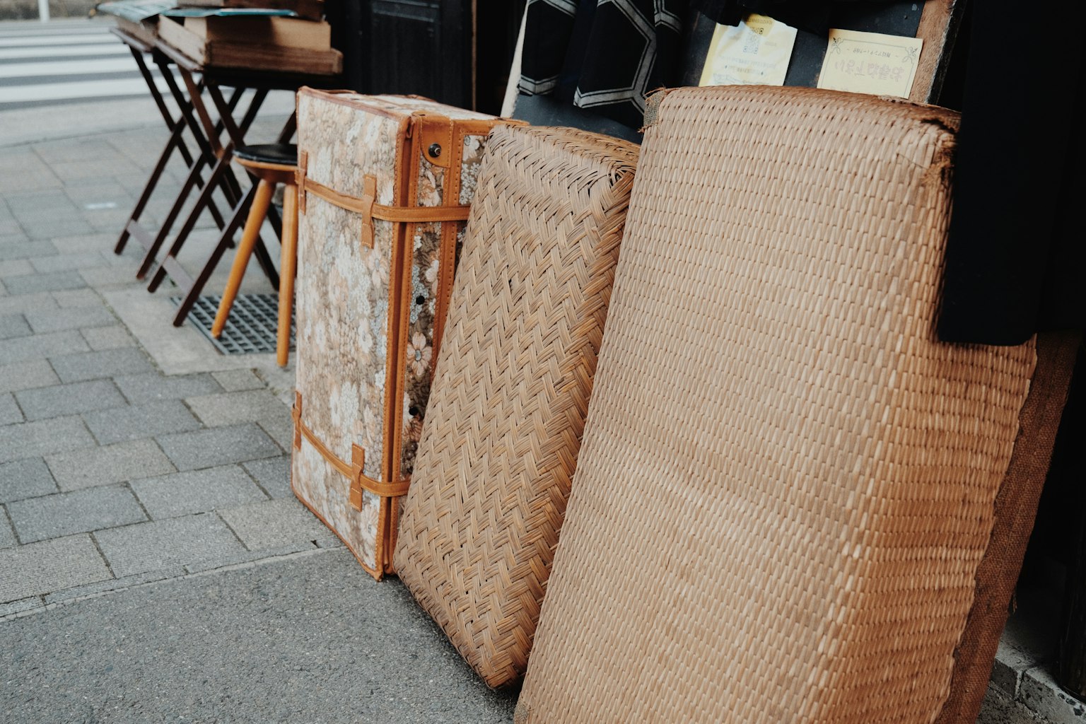Three bamboo mats and a wooden folding table displayed outdoors