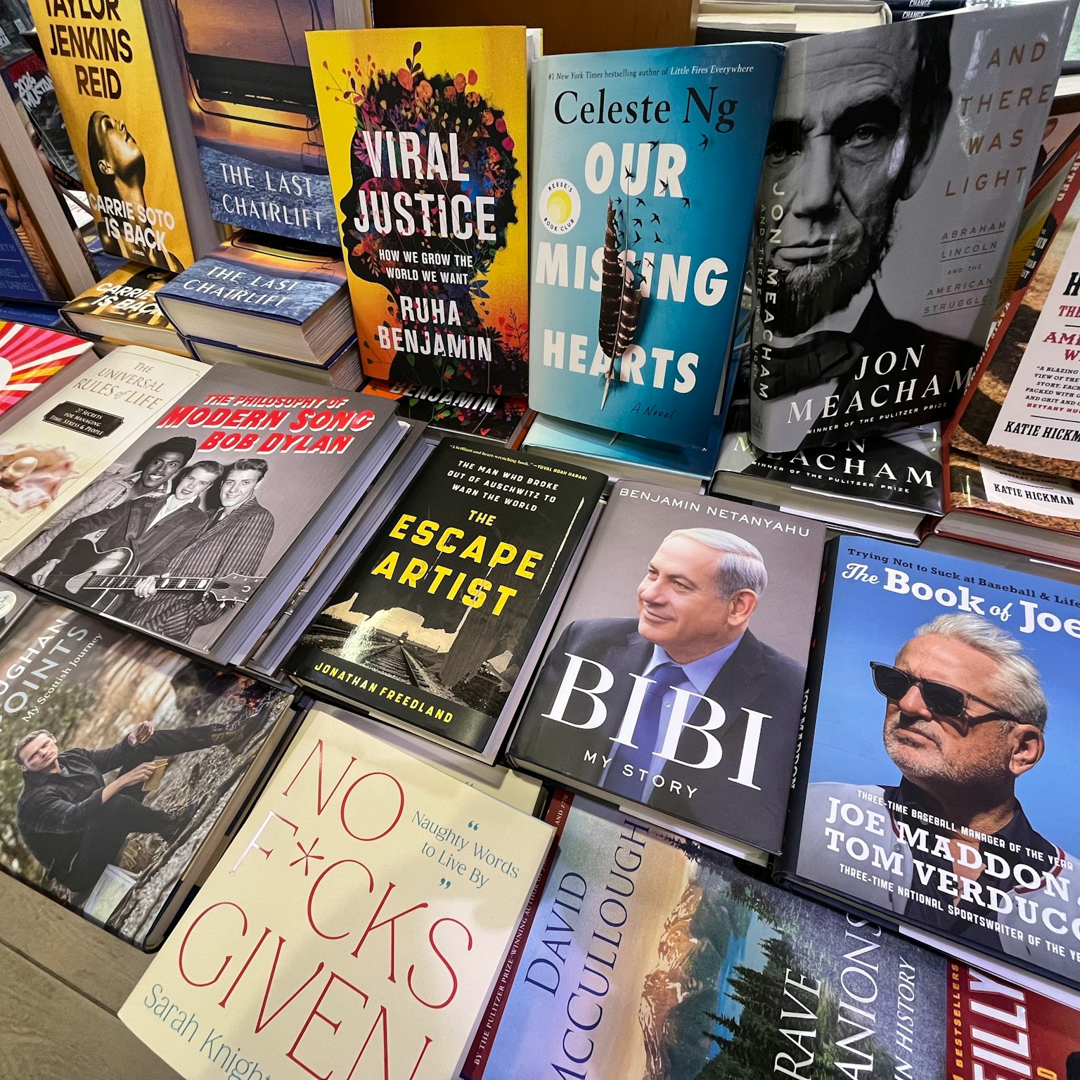 A collection of diverse books displayed on a bookstore table