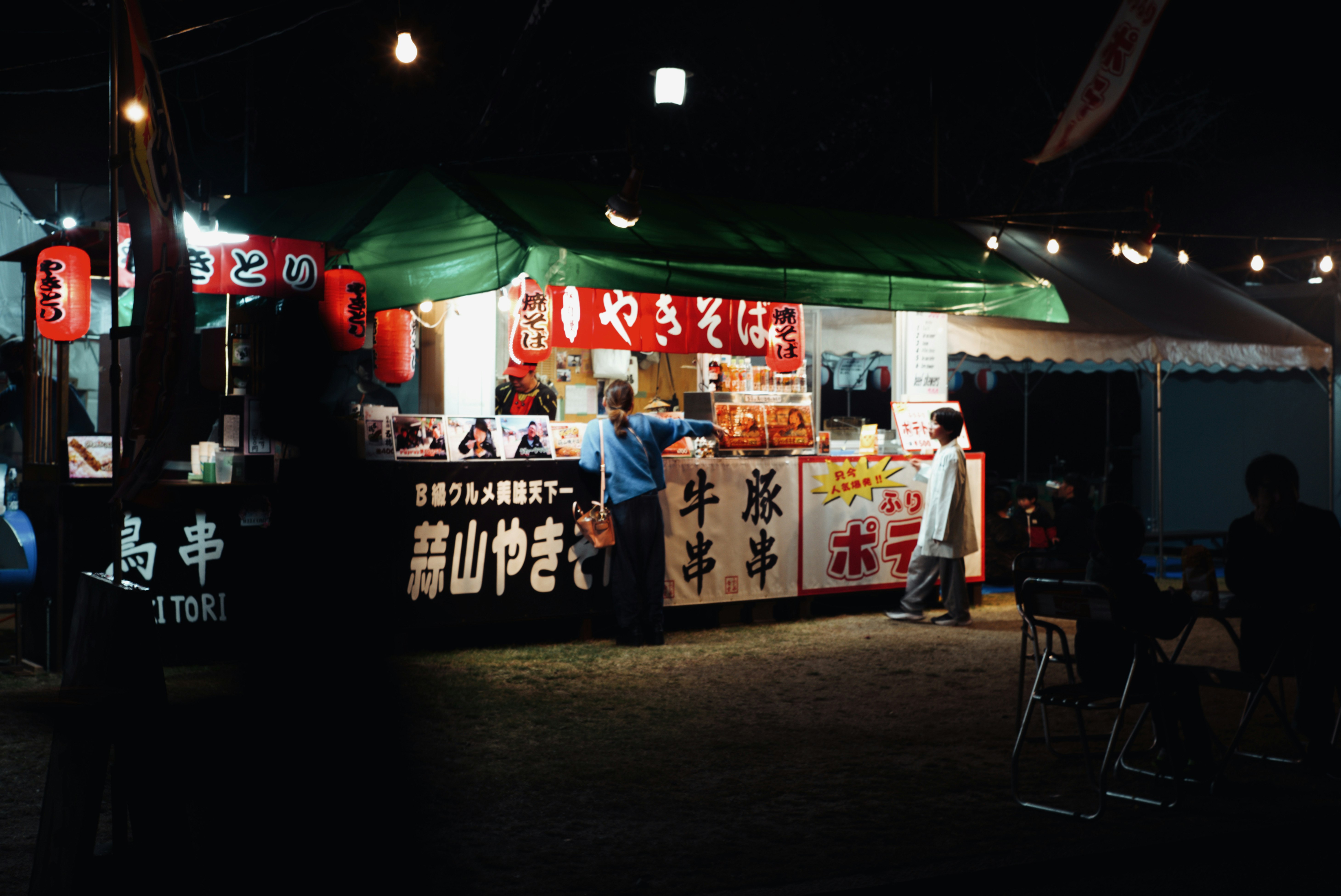 夜の屋台で食べ物を販売する店の様子