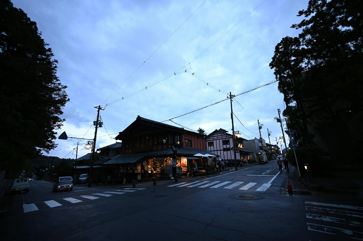 Traditional buildings at a street intersection during twilight