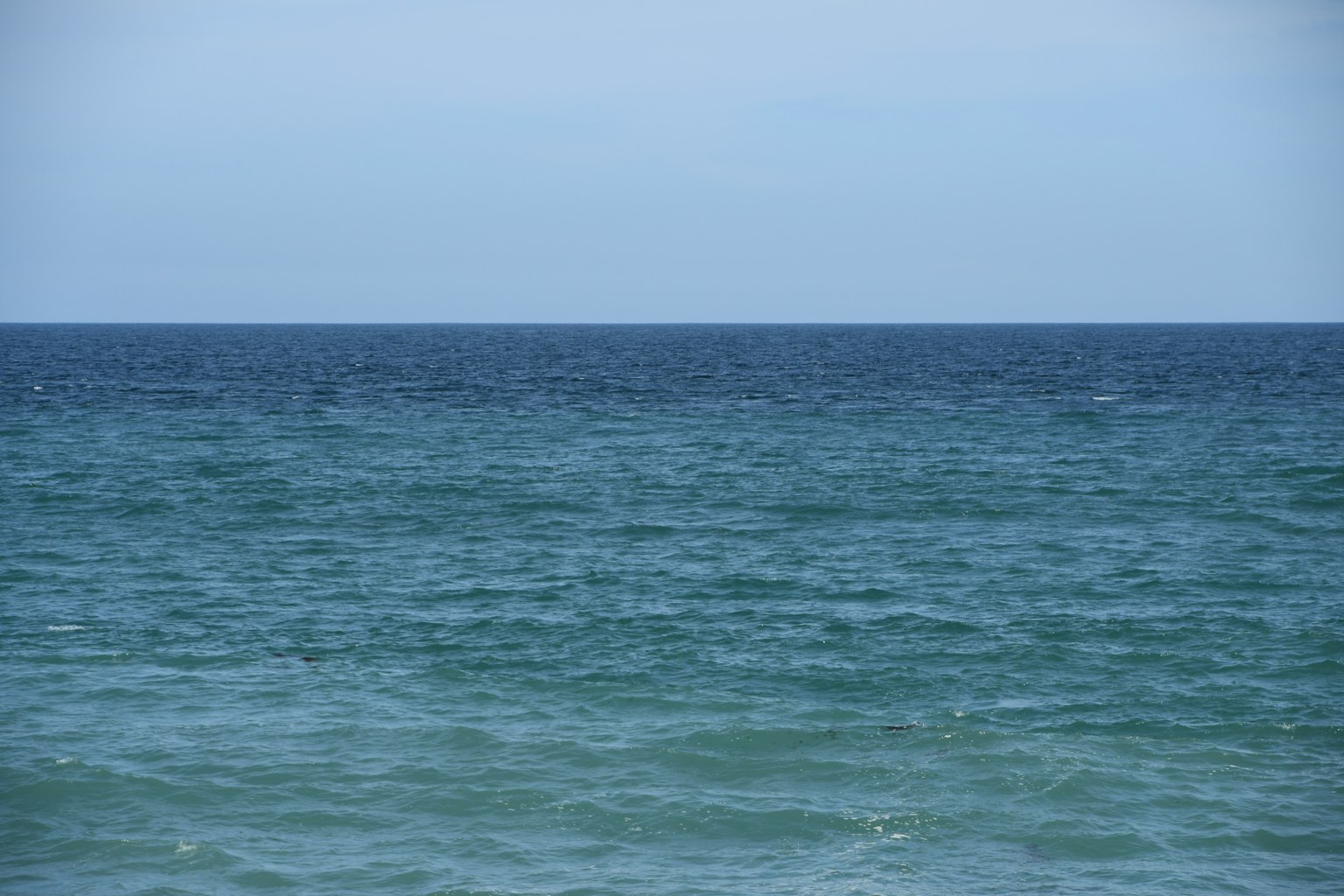 A landscape showing the boundary between blue sea and sky
