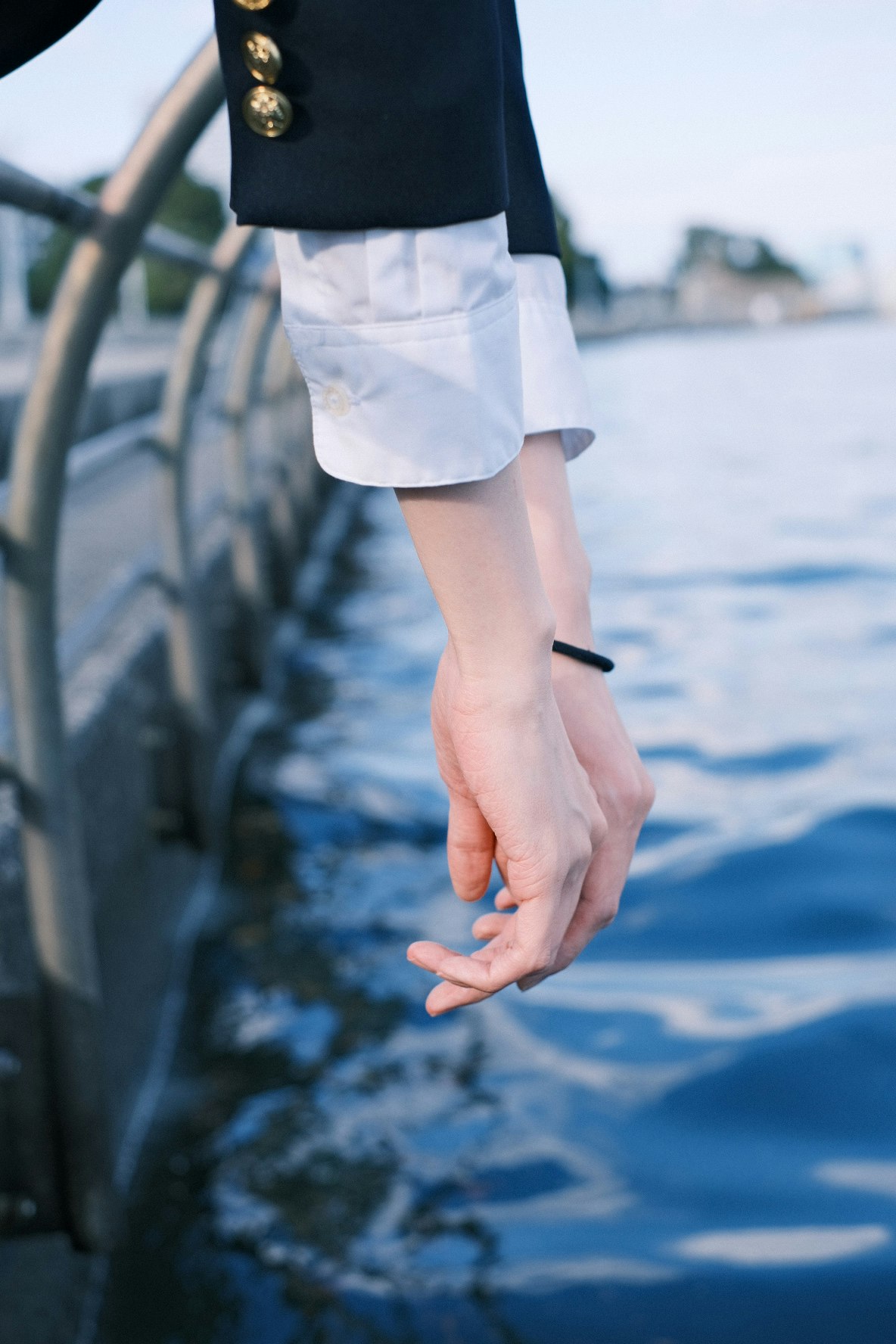 people holding hands on a seaside pier