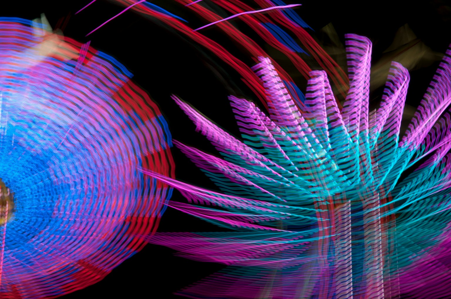 Abstract image featuring vibrant blue and purple light patterns