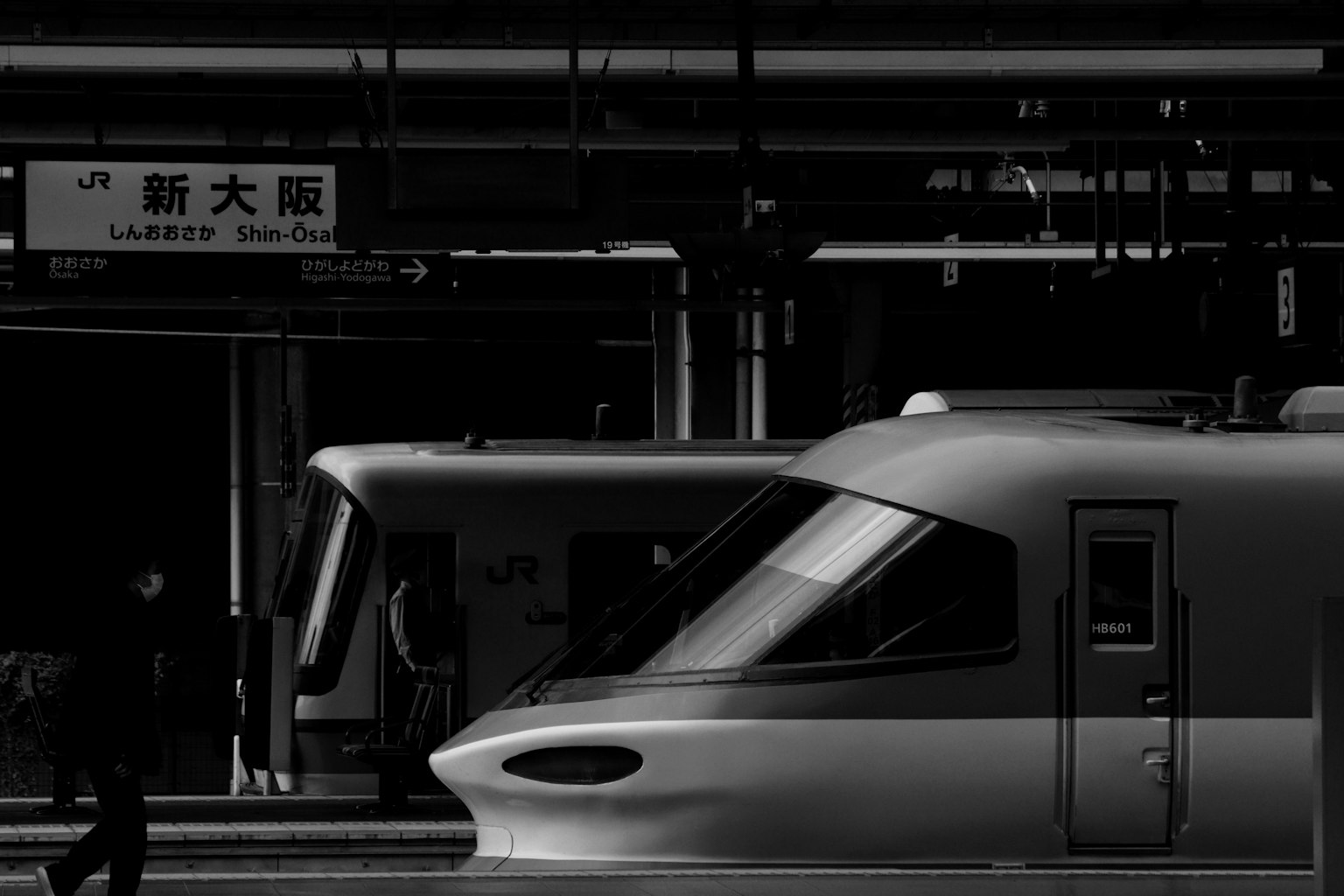 Tampilan samping Shinkansen di Stasiun Shin-Osaka dengan orang-orang
