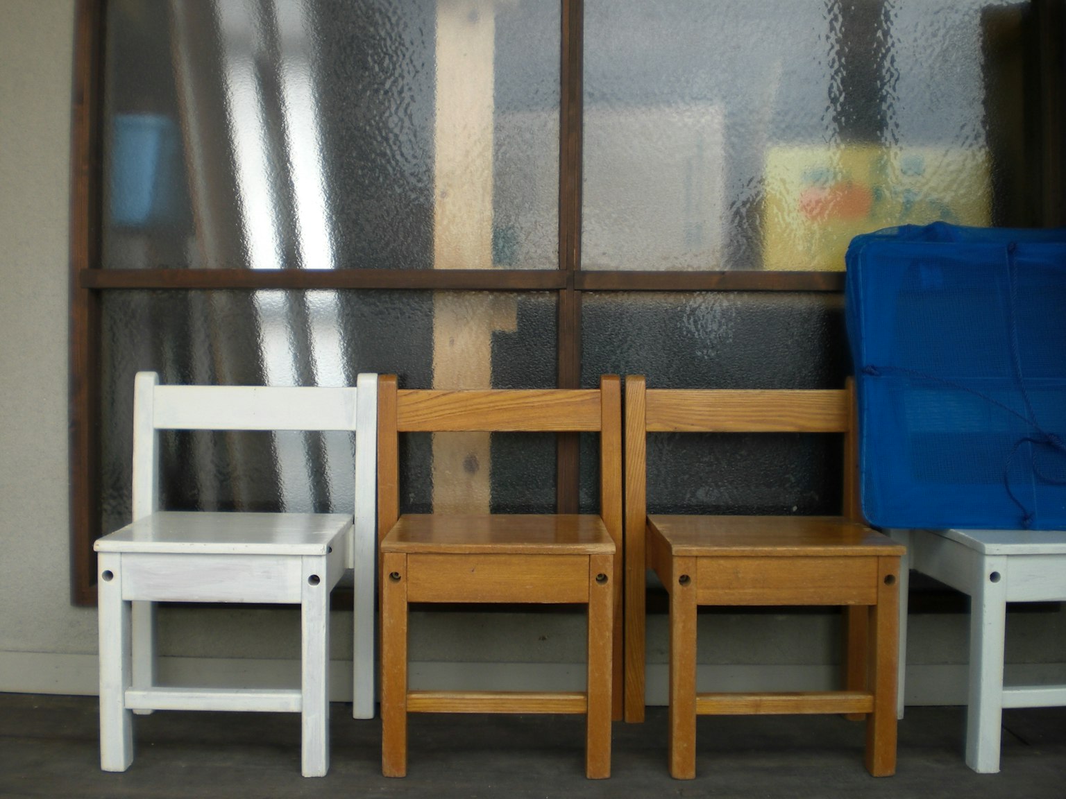 A scene featuring white and wooden chairs arranged indoors