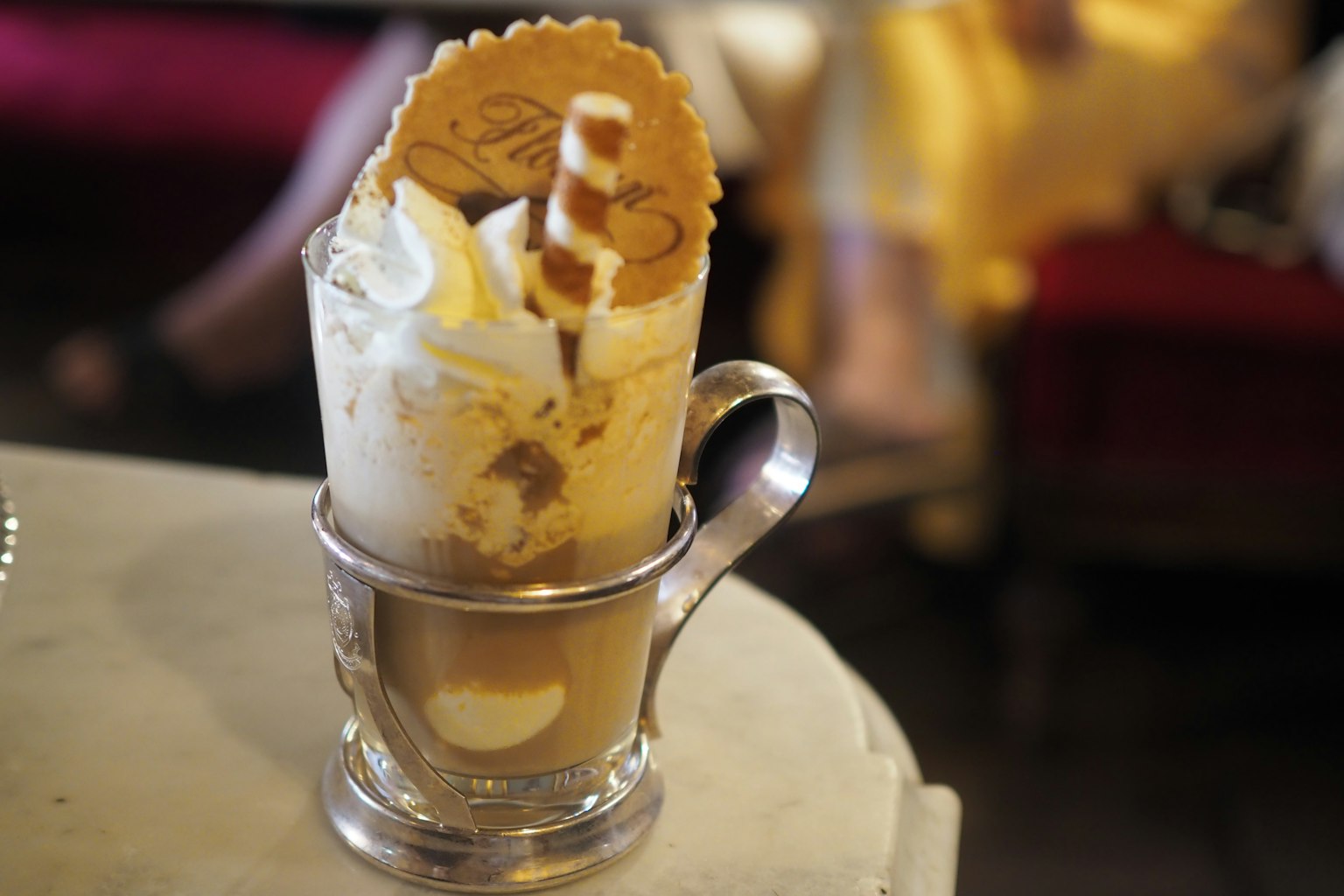 Coffee drink topped with cream and cookies