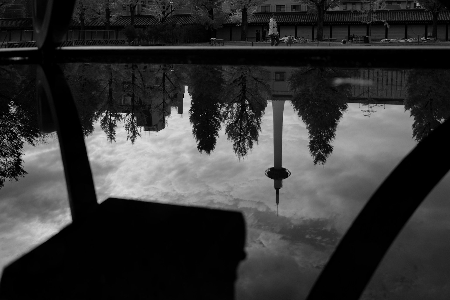 Refleksi menara dan pohon di taman