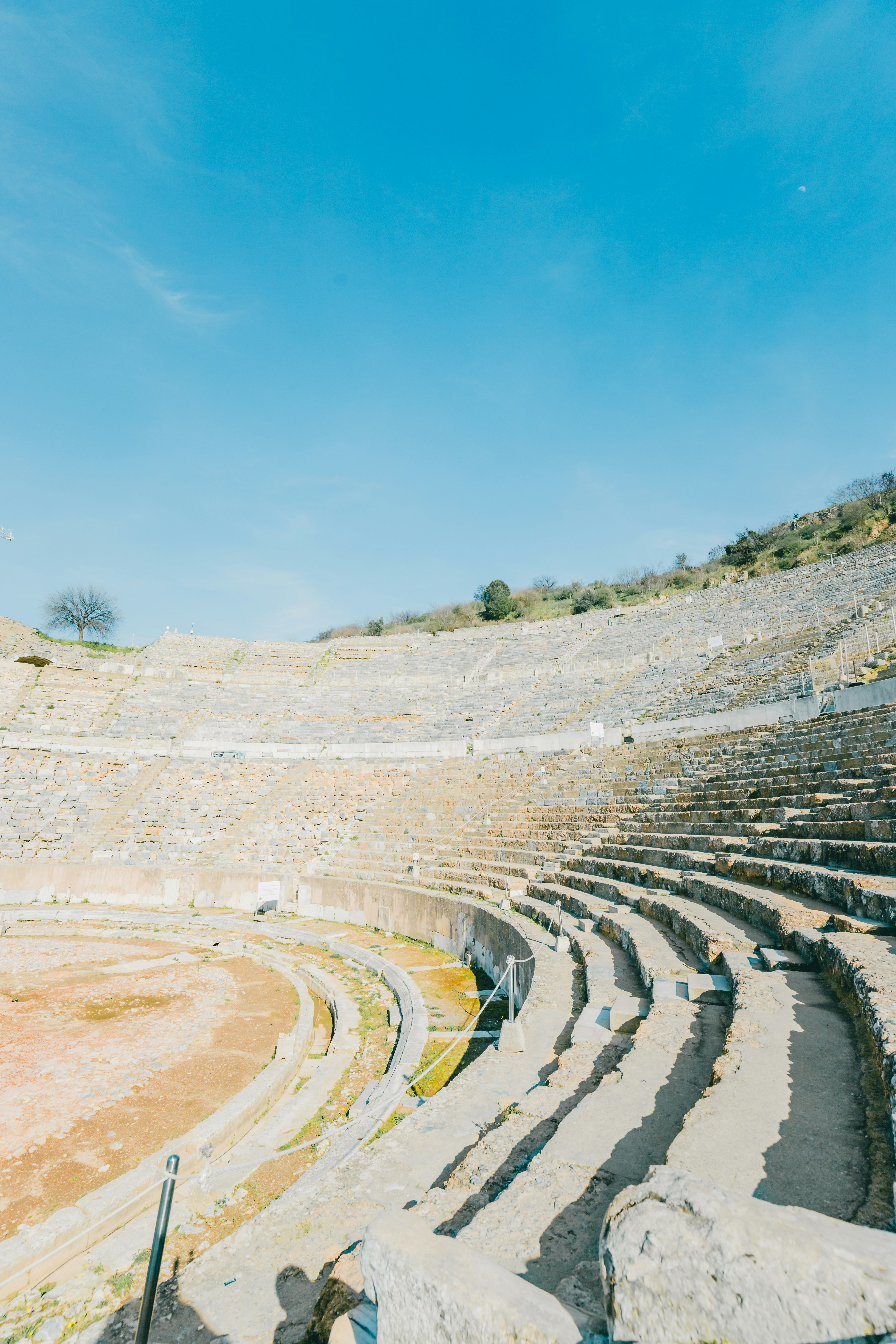 terraced stone ruins under a clear blue sky