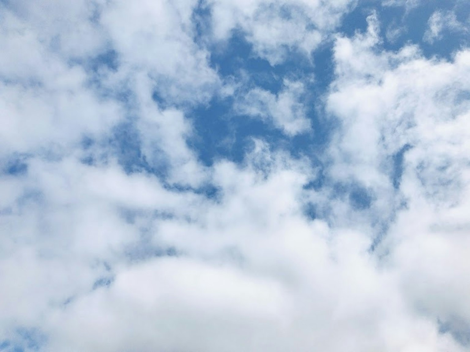 A landscape featuring blue sky and white clouds