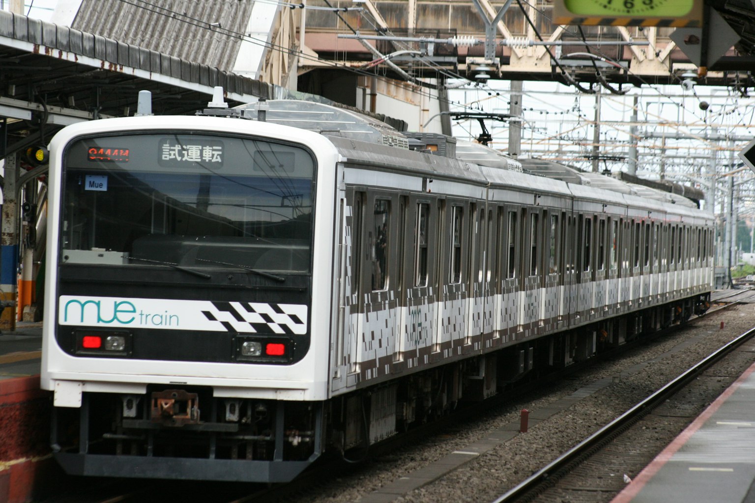 A white and black train is parked at the station