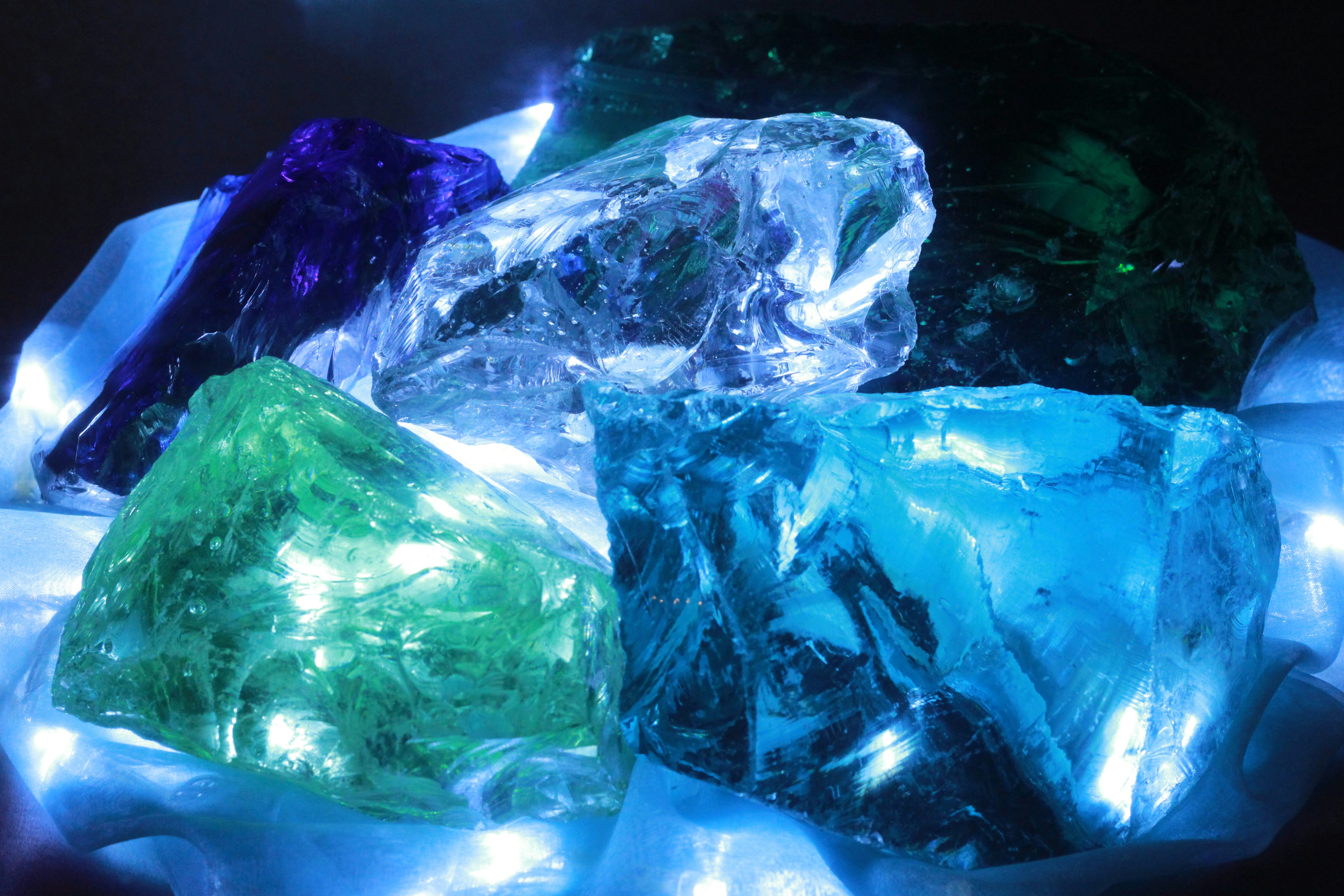 blue-green ice sculpture glowing in the dark