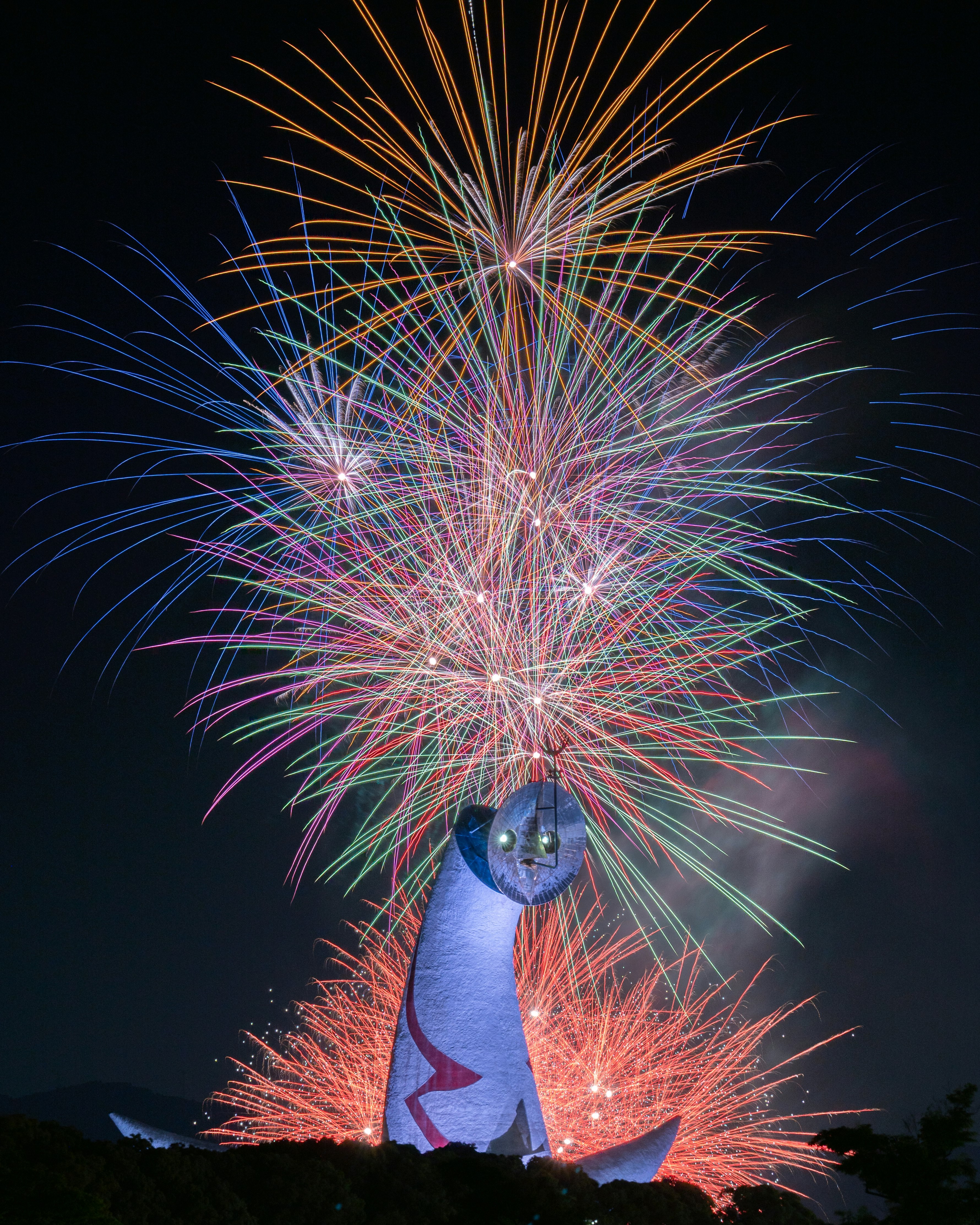 fireworks bursting over a large expo event