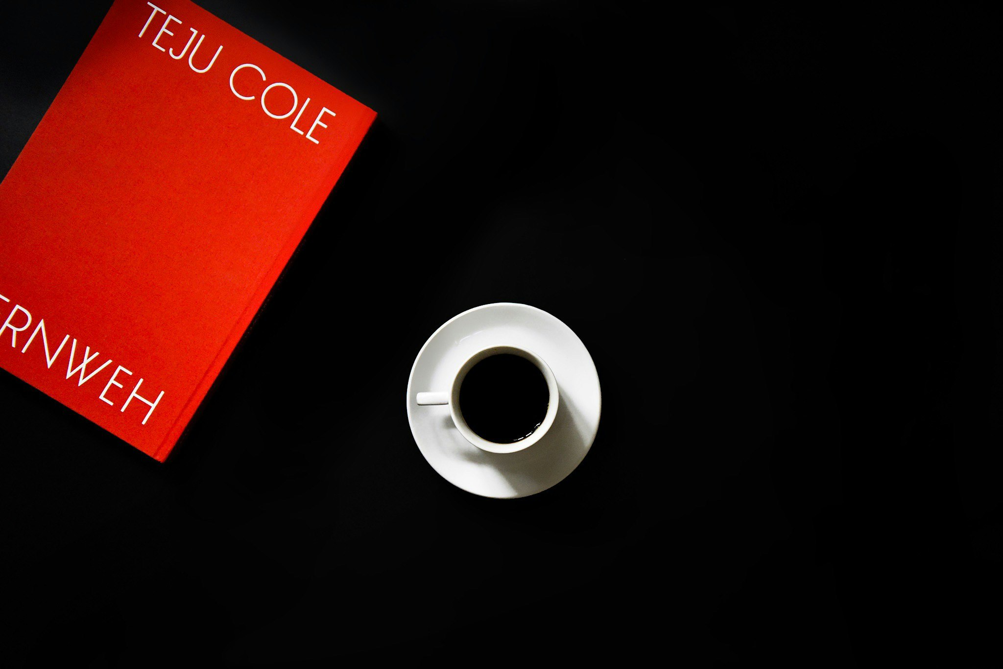 Coffee cup and magazine on a dark table