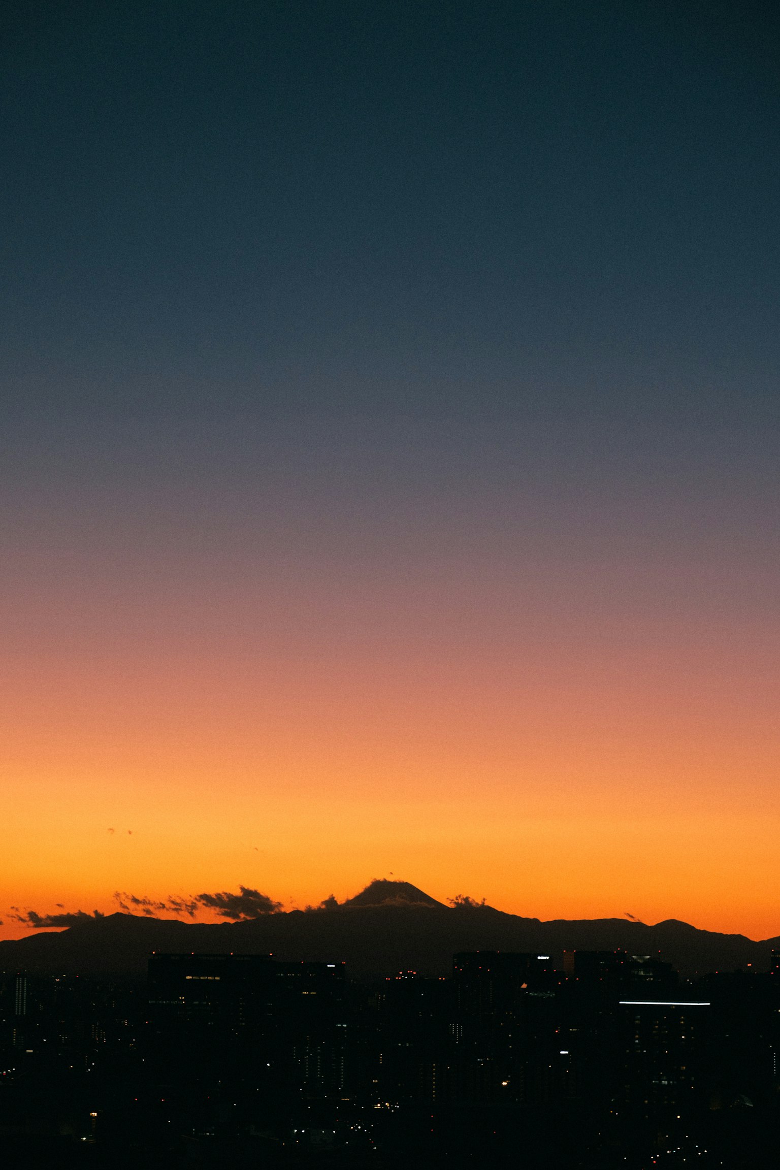 Silueta del monte Fuji contra un vibrante cielo de atardecer