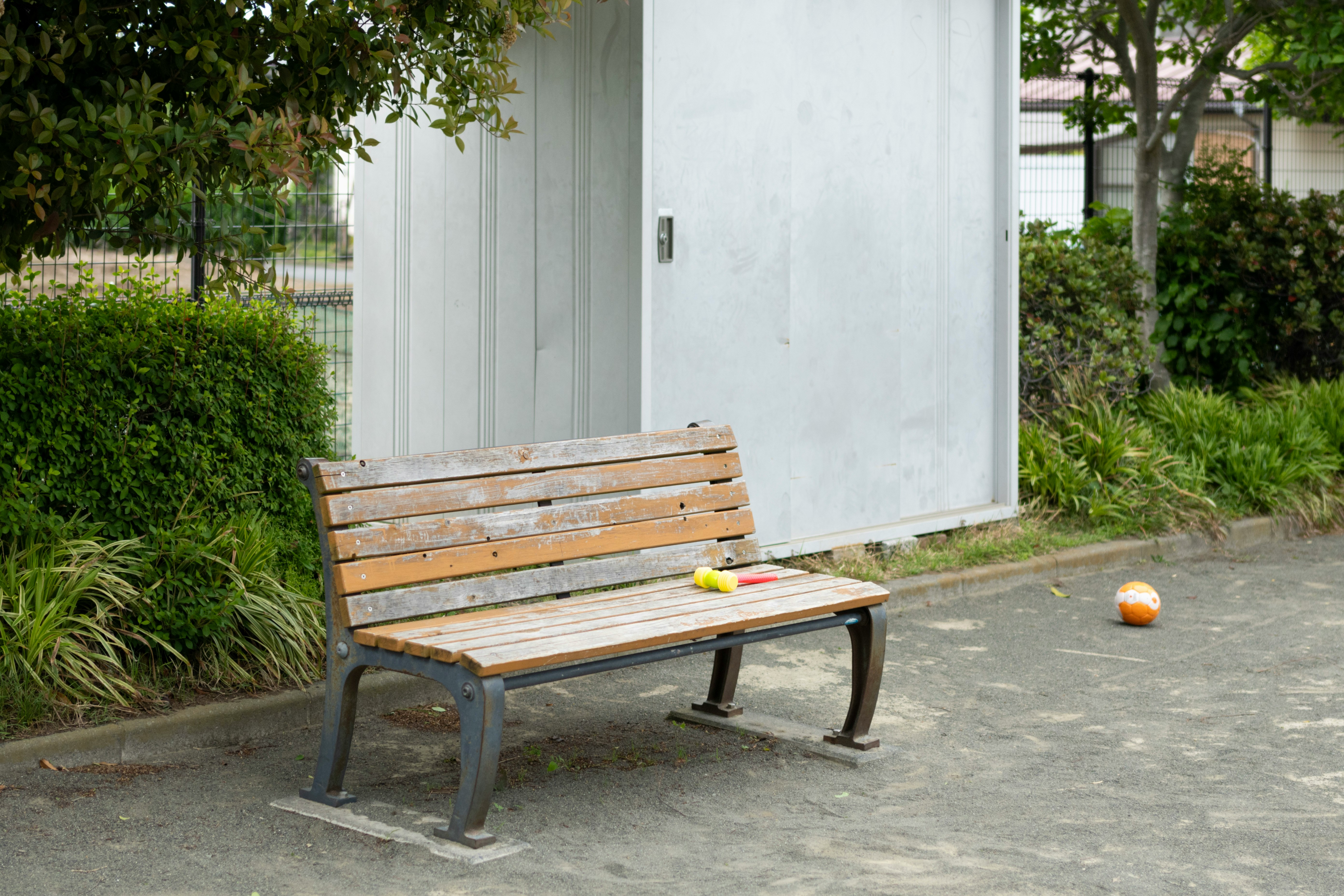 wooden bench placed along a garden path