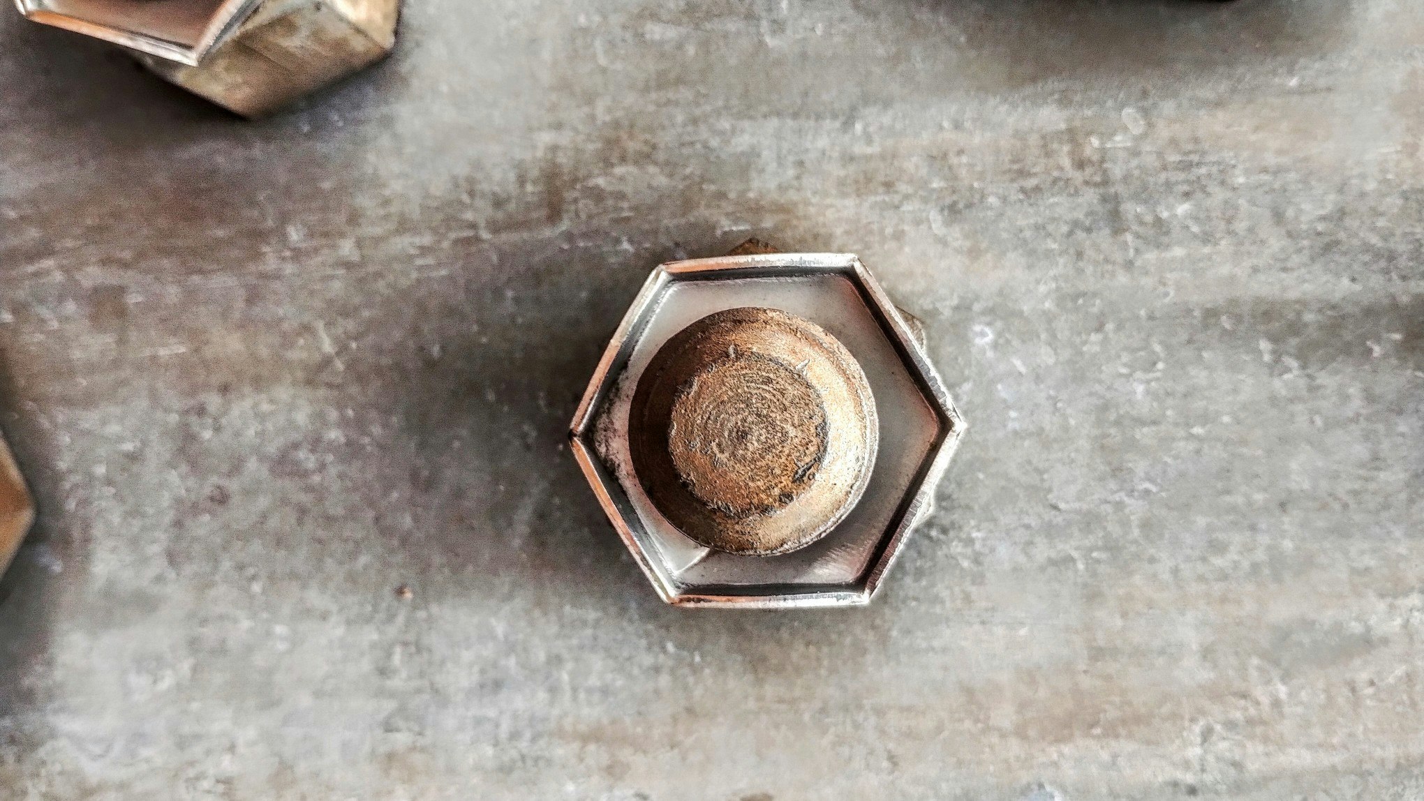 六角菸灰缸裡的螺栓與金屬質感