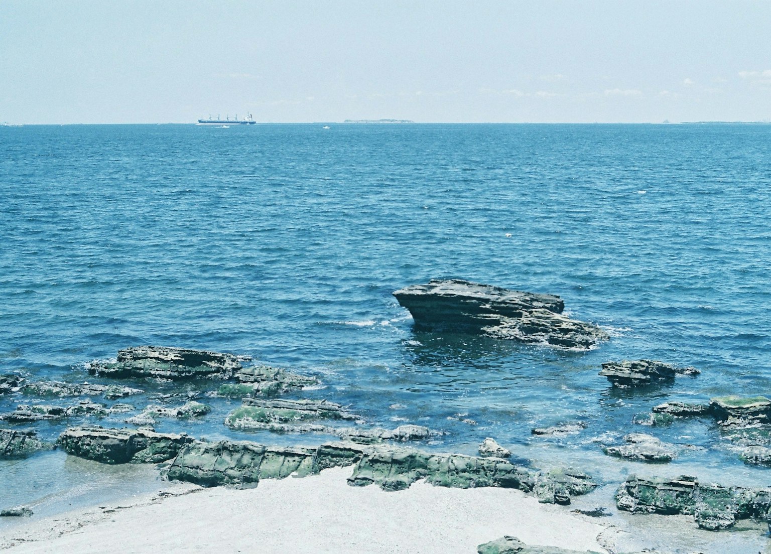 Scenic view of a rocky beach with blue ocean
