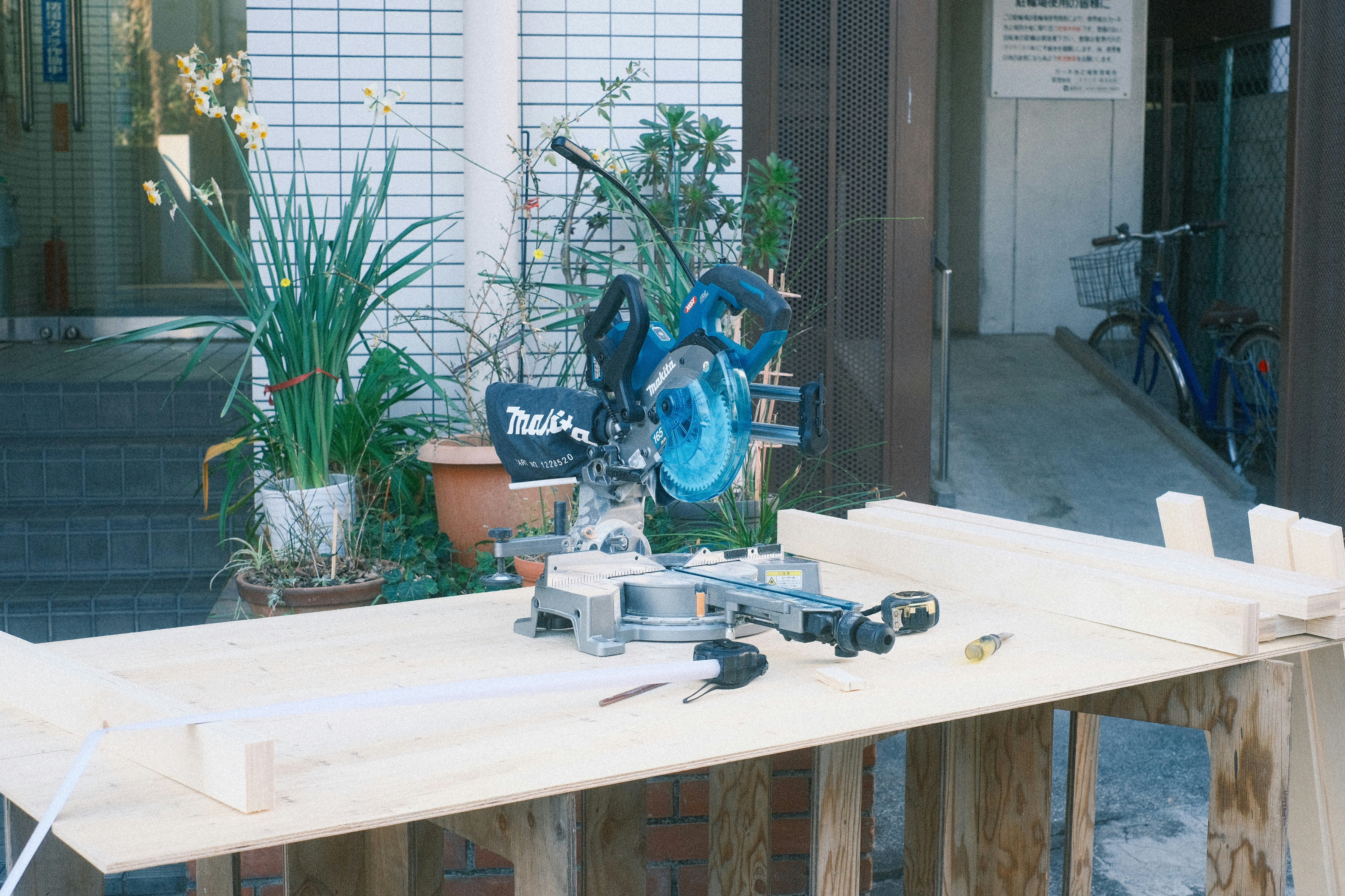 tools and wood pieces arranged on a workbench in an indoor workshop