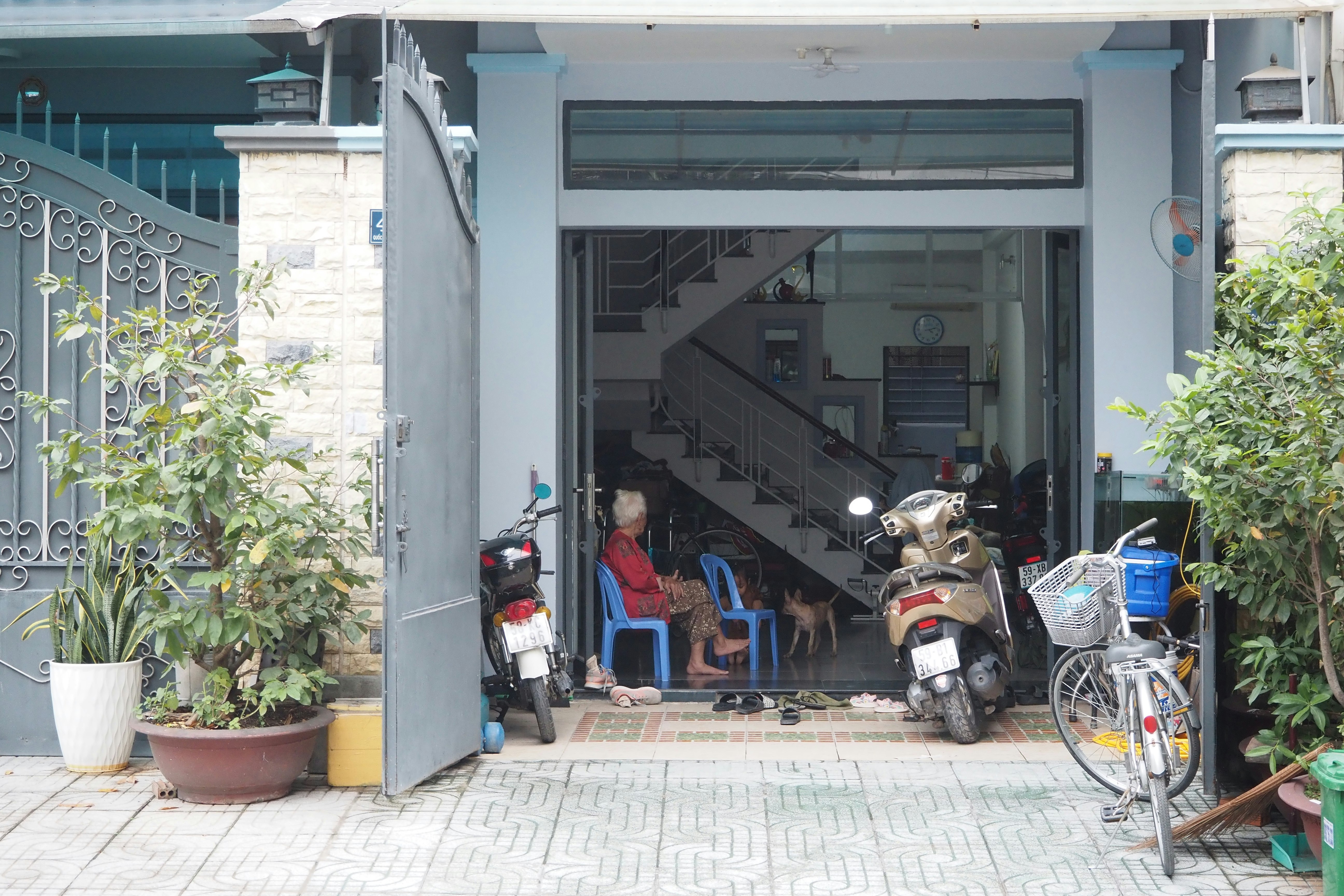 courtyard entrance with potted plants and parked bicycles