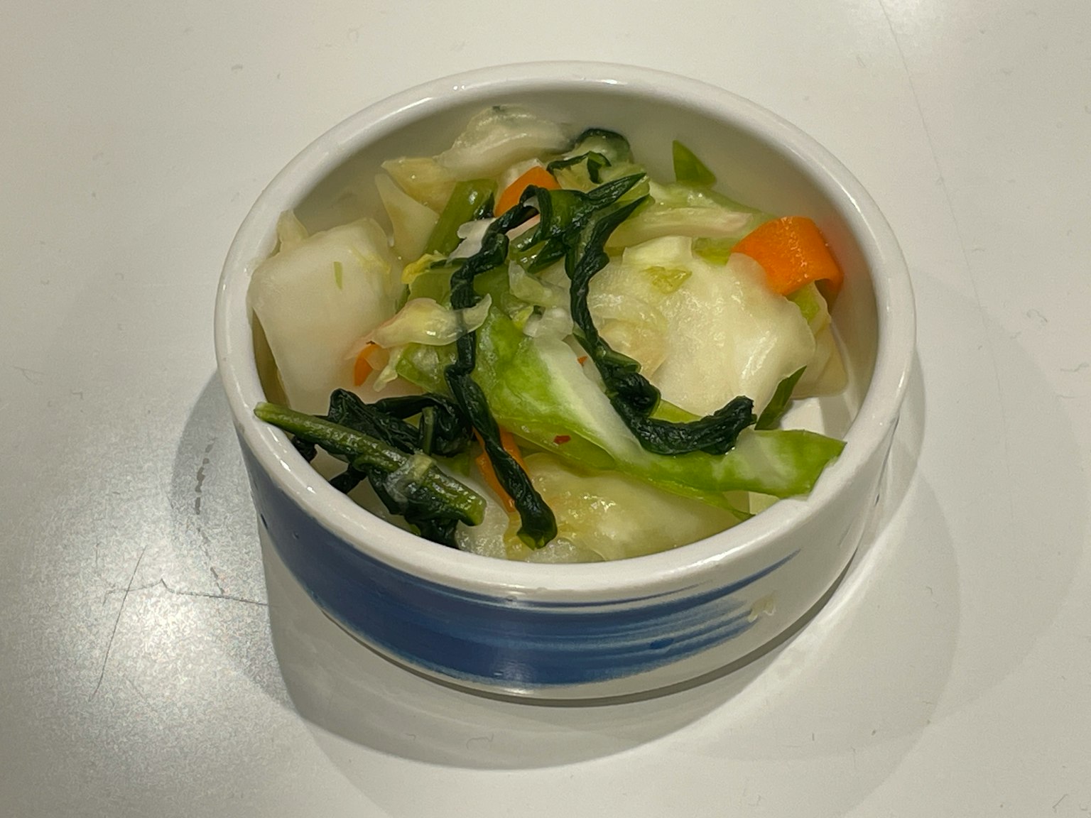 Colorful vegetable salad in a small white bowl