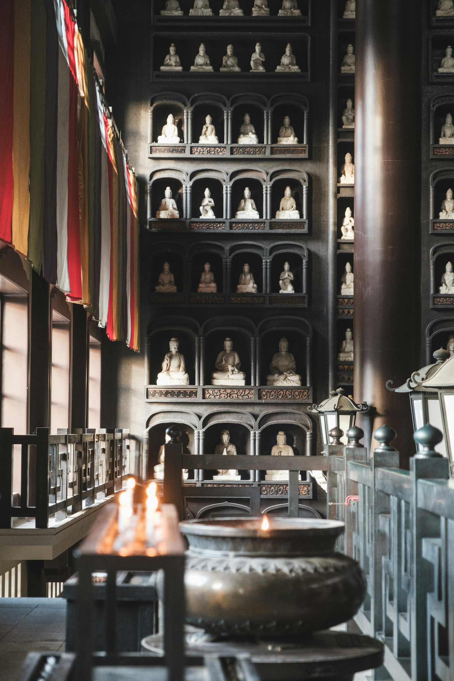Interior view of a serene temple with rows of Buddha statues