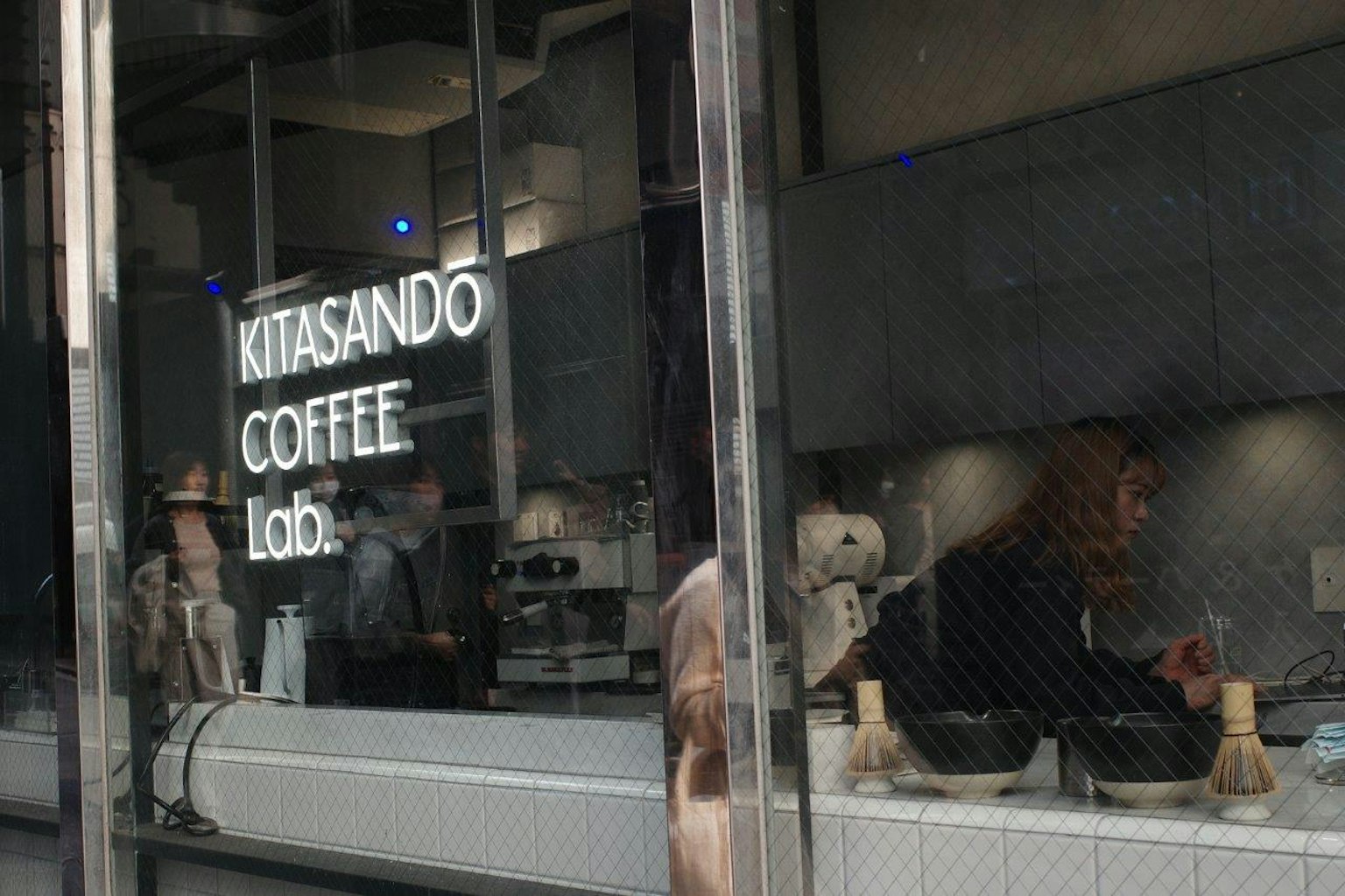 Außenansicht des Kitasando Coffee Lab mit Menschen, die Kaffee zubereiten