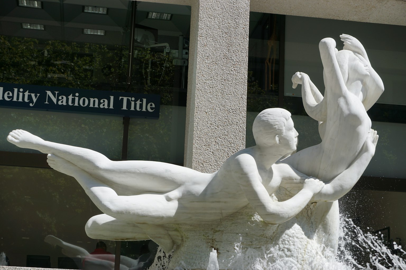 White sculpture fountain featuring a man and a woman