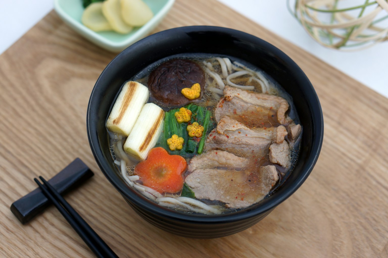 A beautiful bowl of ramen with sliced meat and colorful vegetable toppings