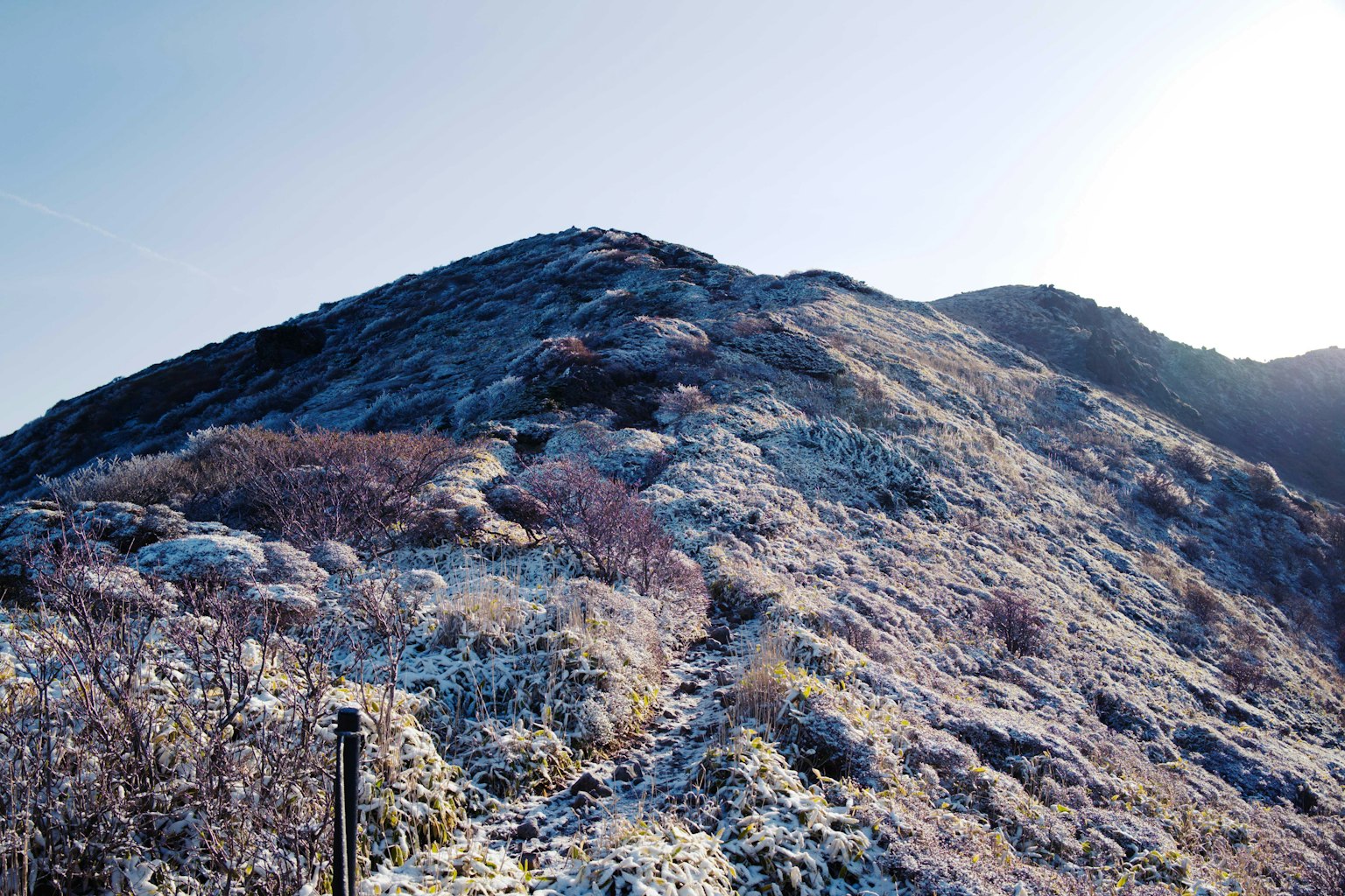 Snow-covered mountain landscape with clear blue sky