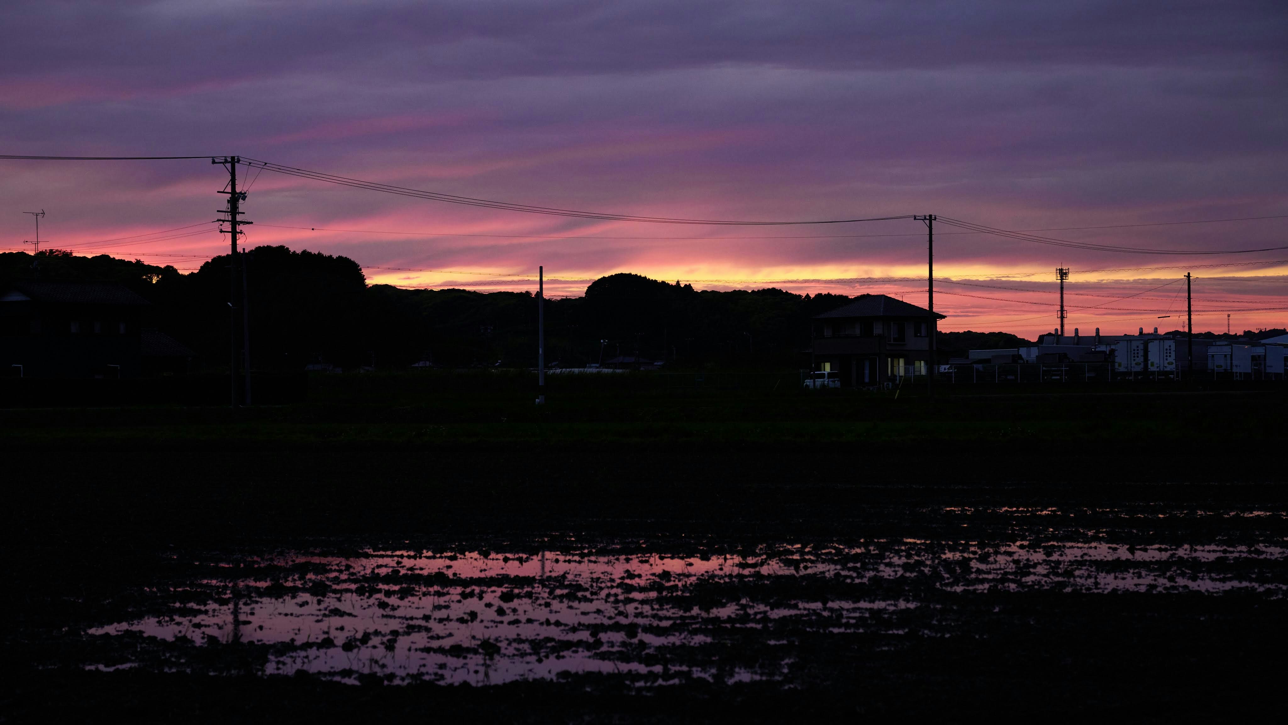 夕焼けの空と水面に広がるシルエットの風景
