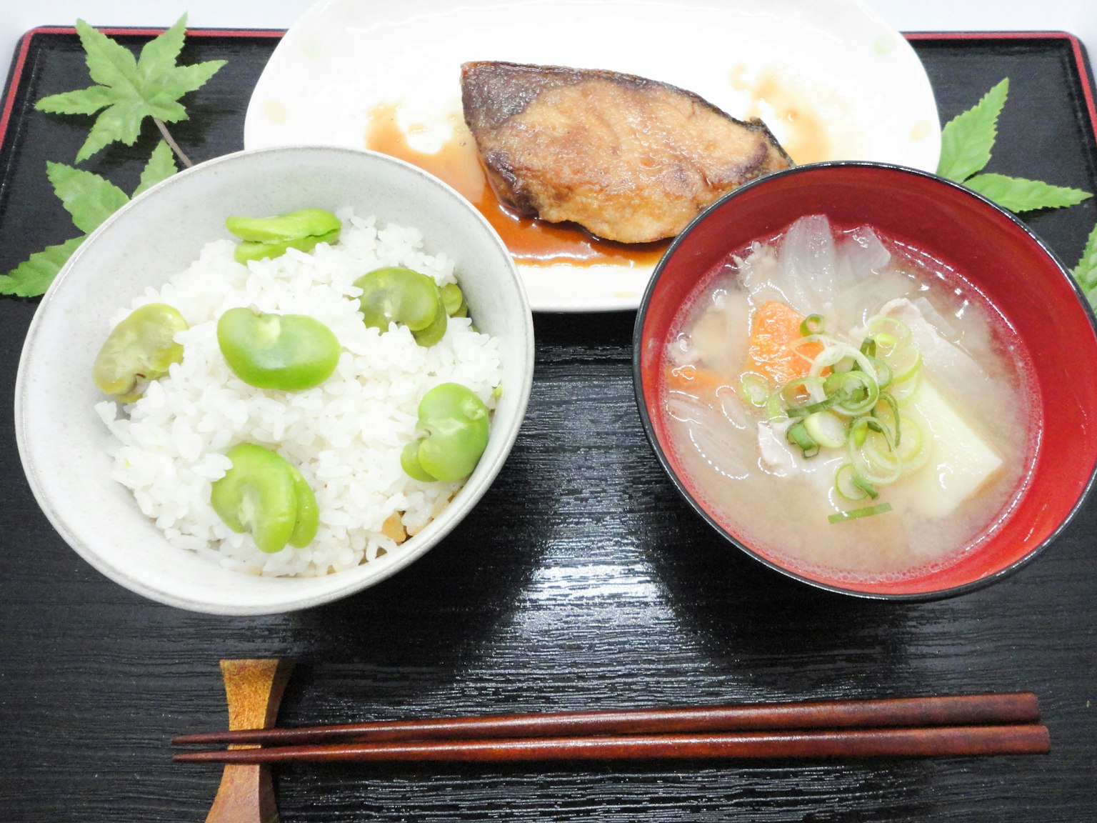 Assiette de cuisine japonaise avec du riz garni de fèves de broad poisson teriyaki et soupe miso avec des légumes