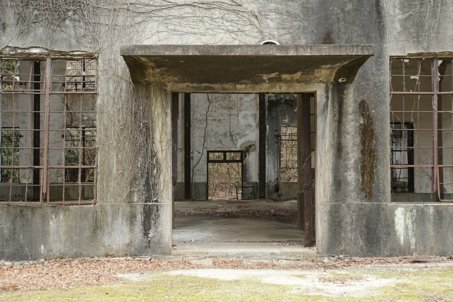 Entrance of a dilapidated building with barred windows