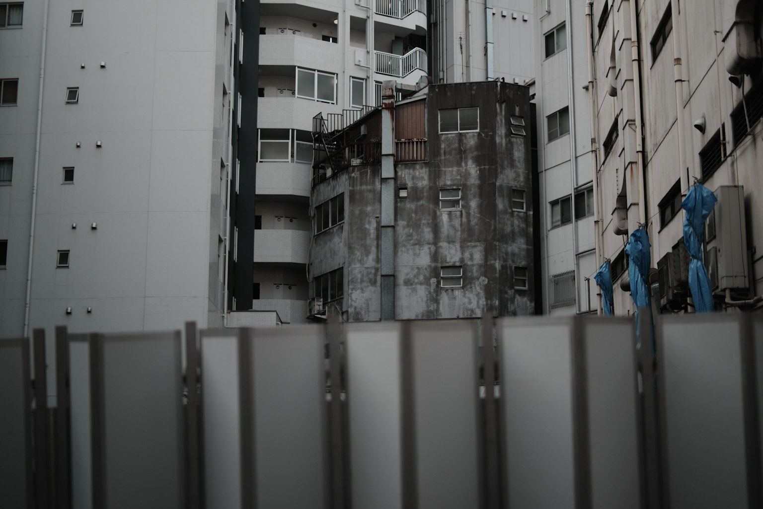 Urban landscape featuring buildings and construction fence