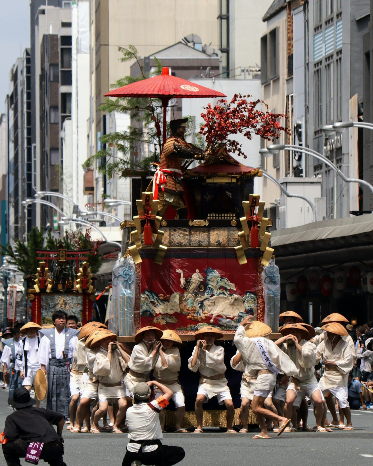 节日花车在街上游行，参与者穿着传统服装