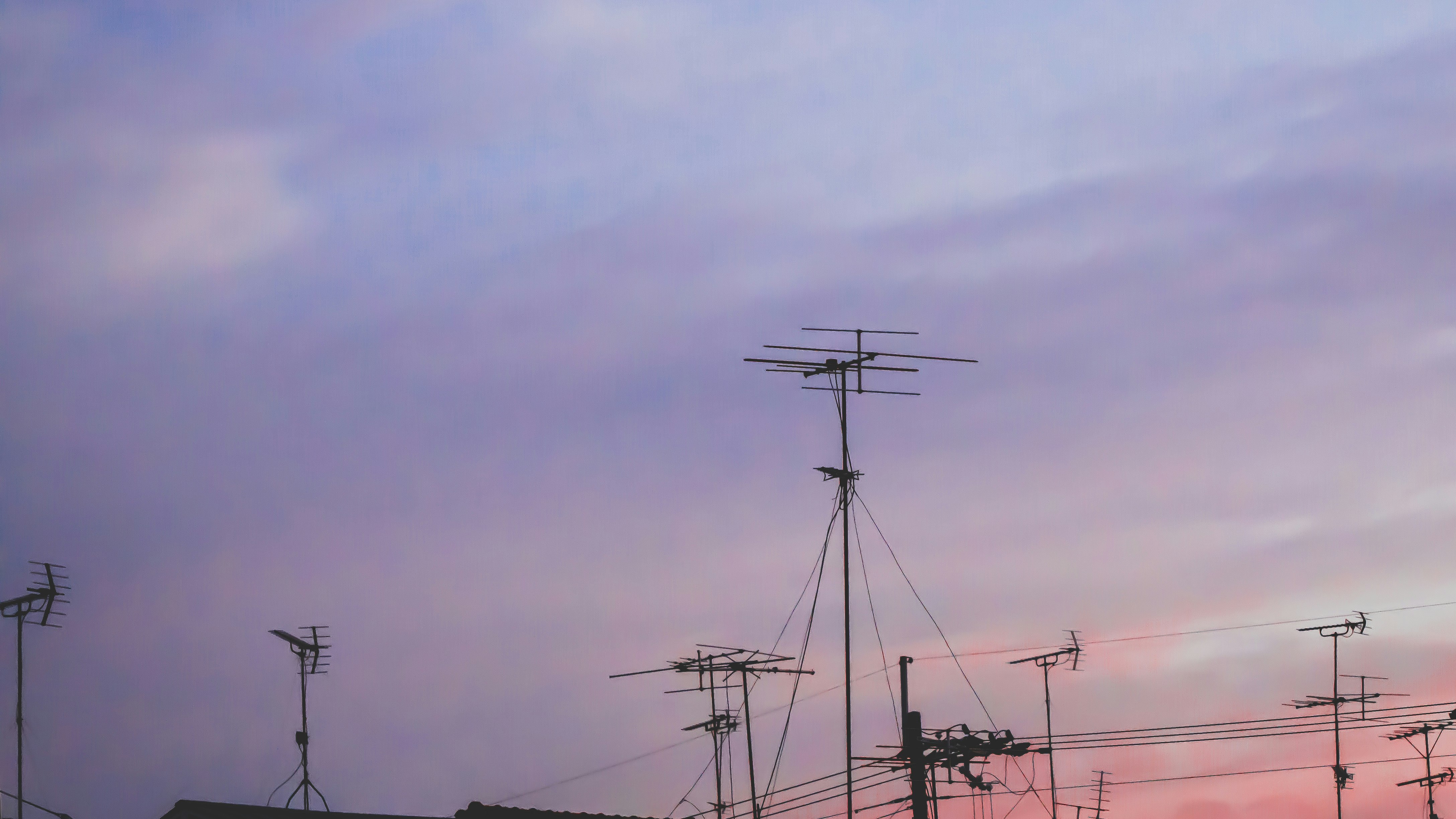 power poles and antennas against a dusk sky