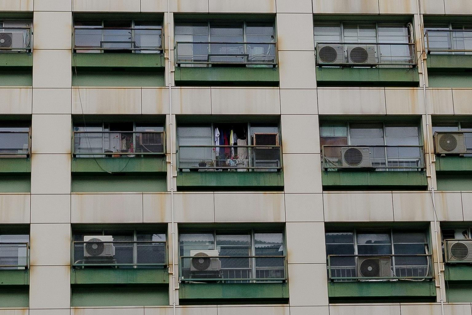 Rangées d'unités de climatisation et de fenêtres sur la façade d'un bâtiment