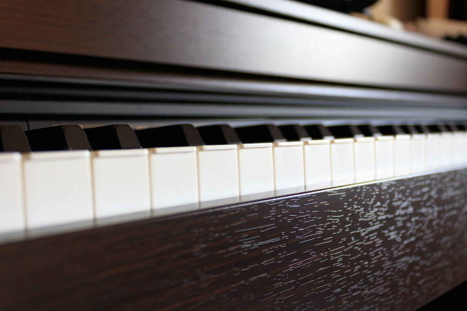 Close-up of a piano keyboard featuring black and white keys
