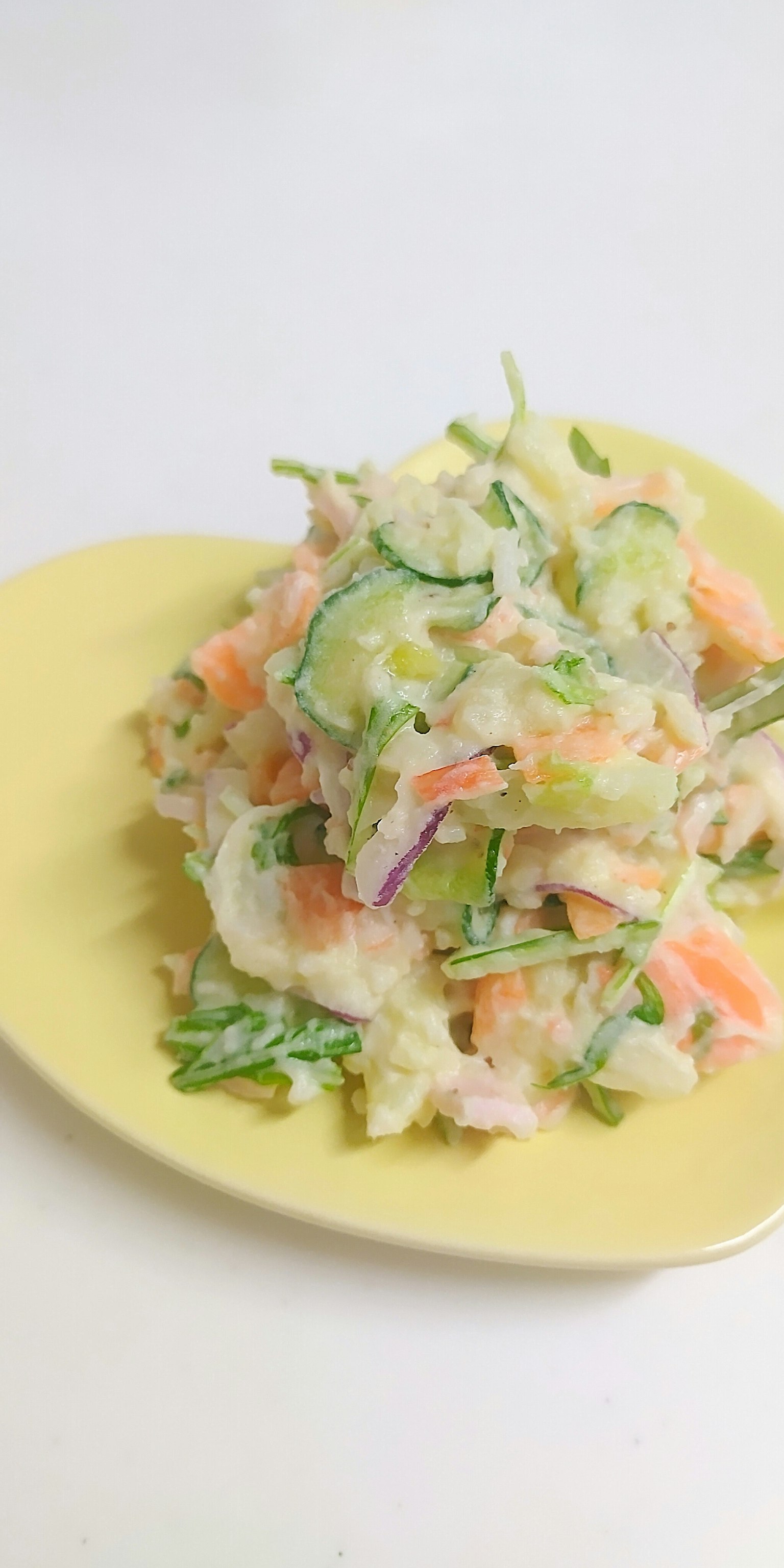 Colorful vegetable salad served on a yellow plate