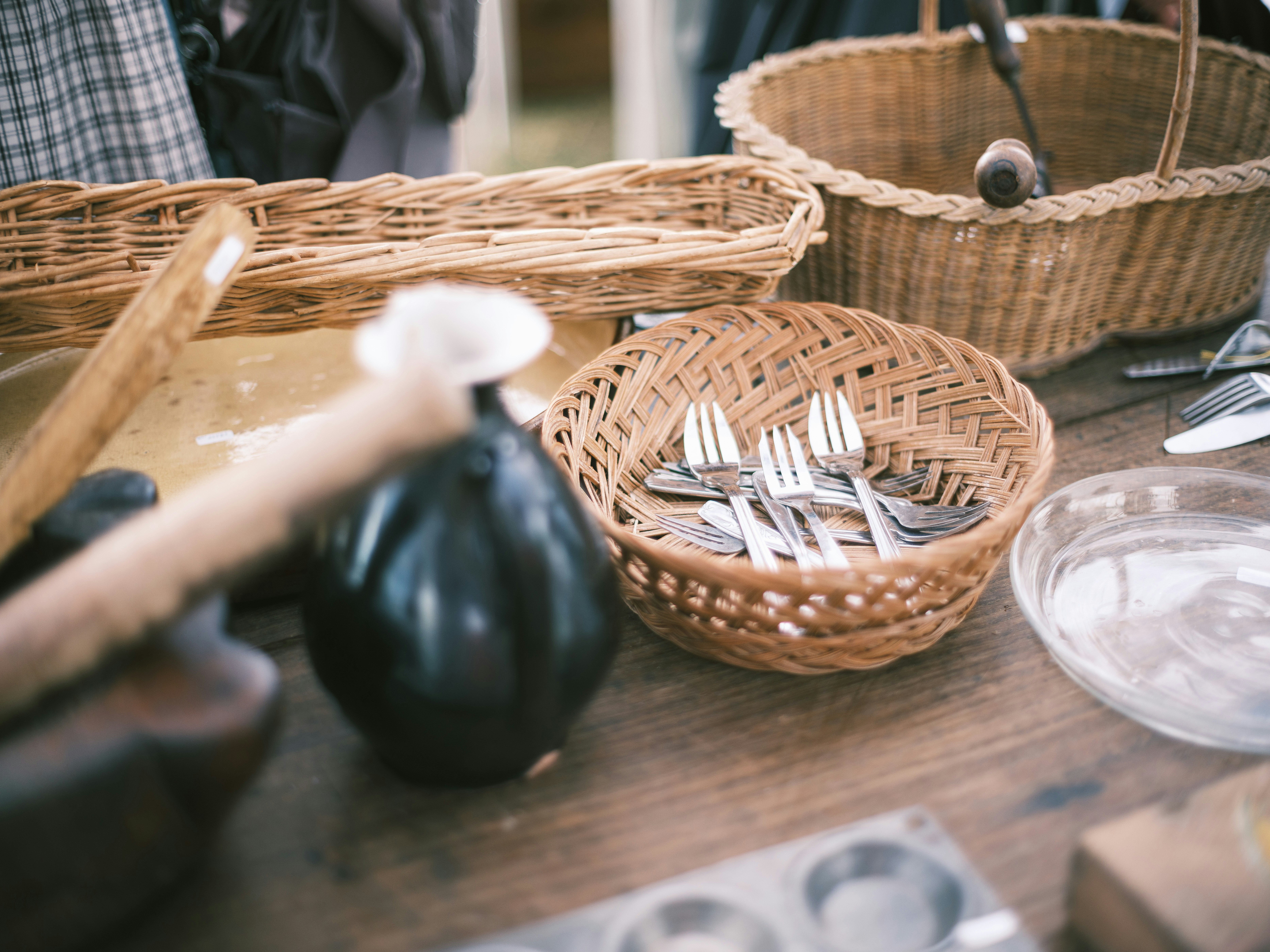 Antique market table with woven baskets and small items