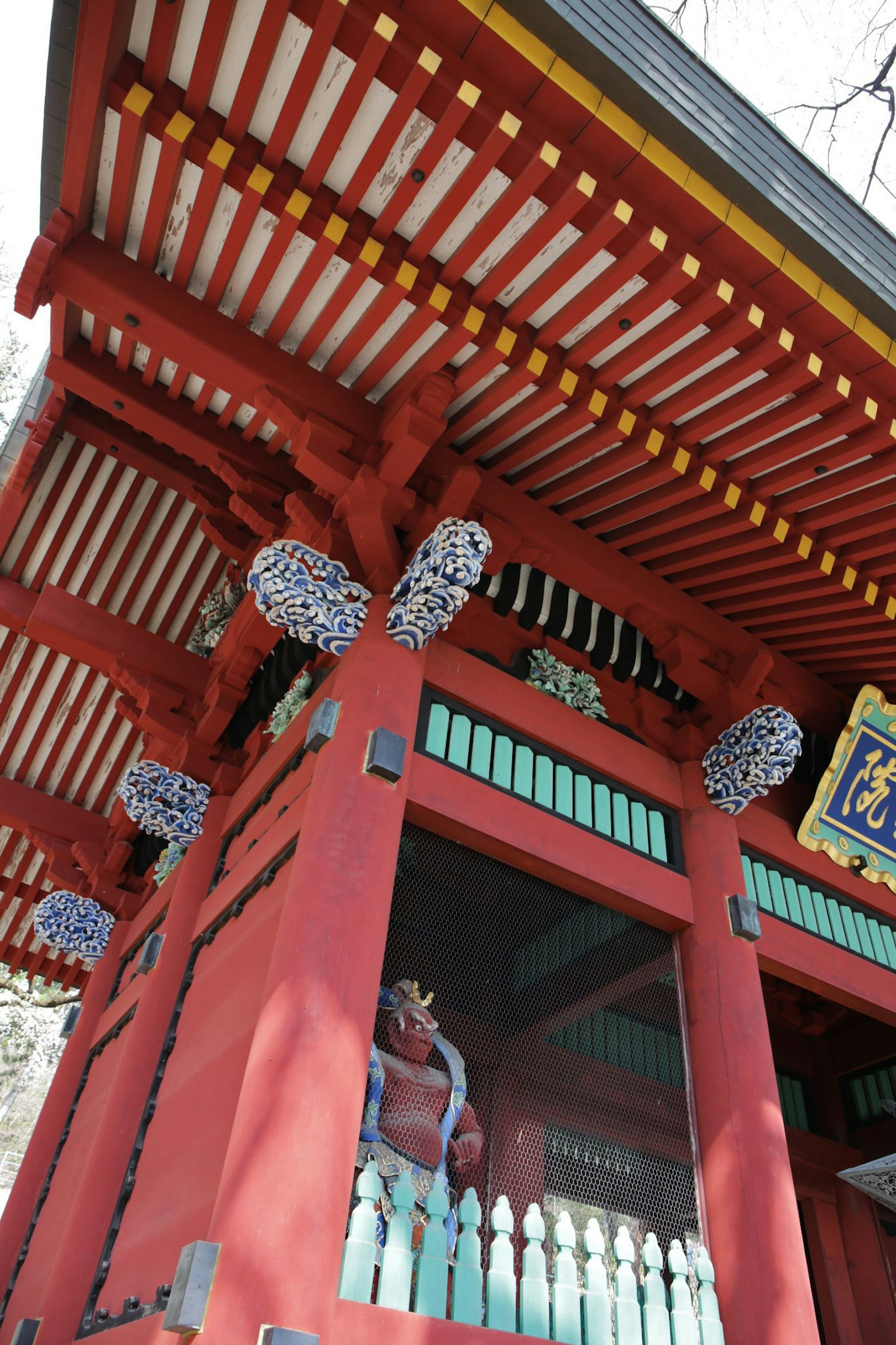 붉은 구조와 장식 기둥, 다채로운 지붕이 있는 신사 문