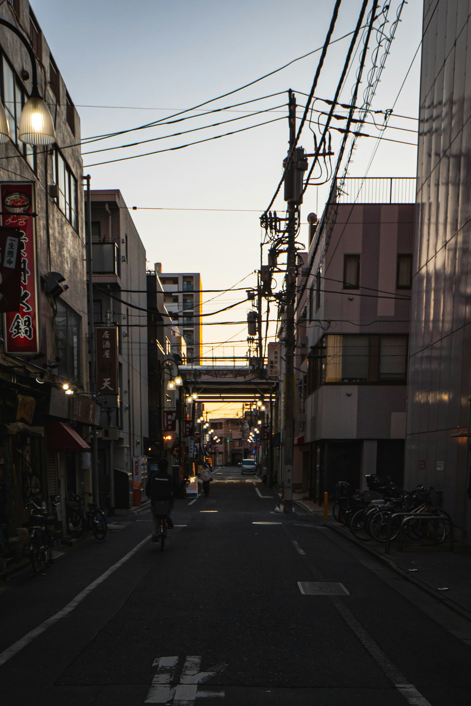 City street at dusk with buildings and power lines