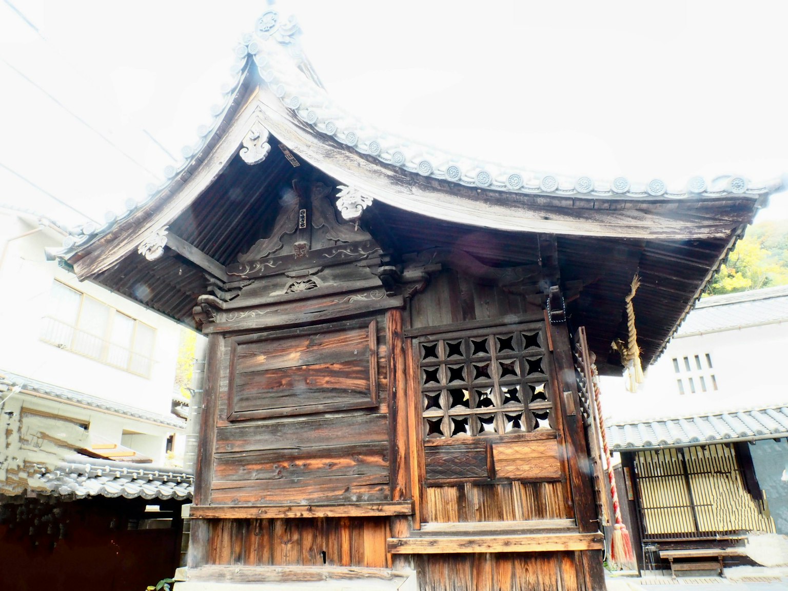 Traditional wooden shrine architecture with a curved roof