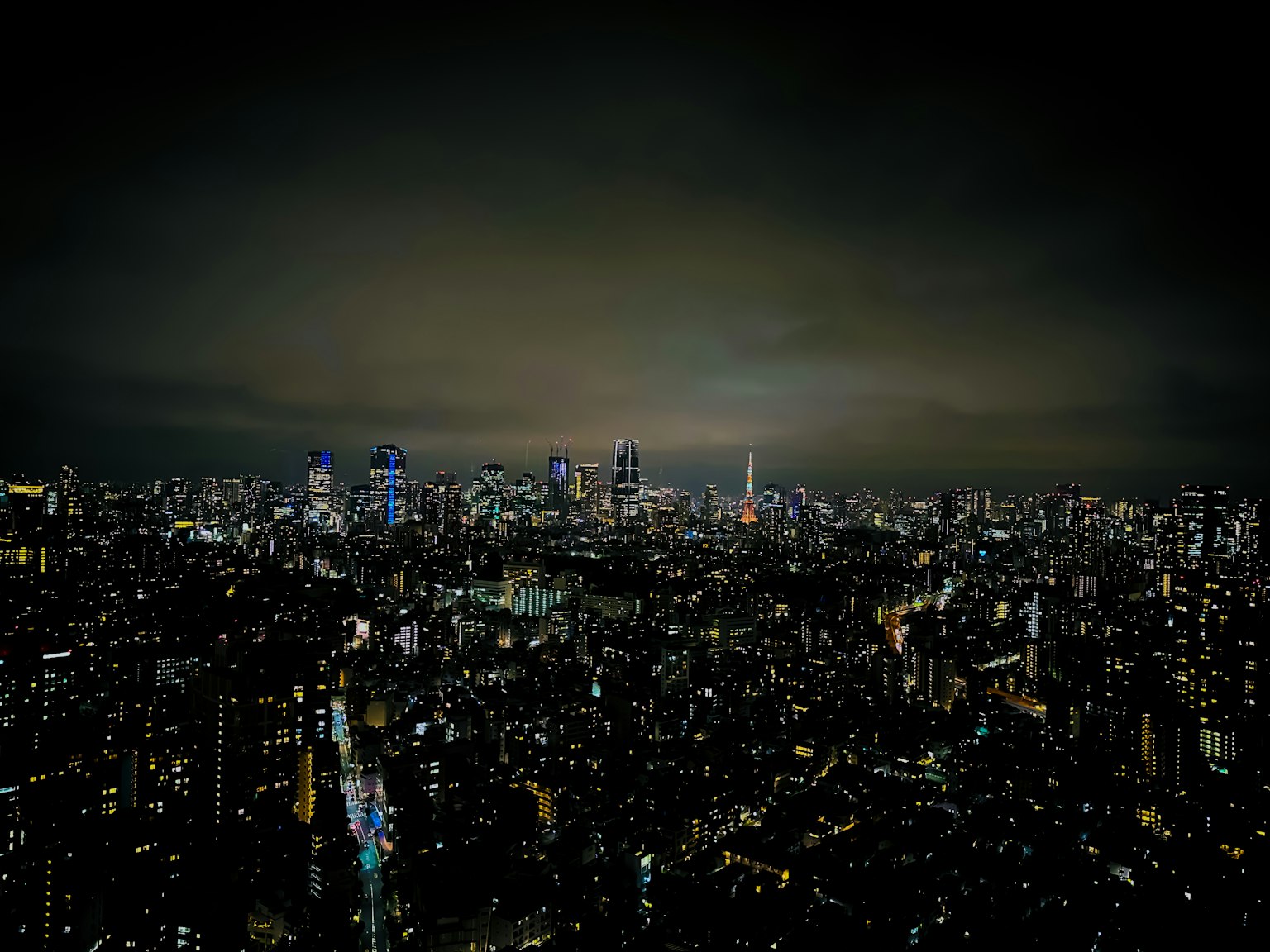 Pemandangan panorama cakrawala Tokyo di malam hari dengan gedung pencakar langit yang diterangi