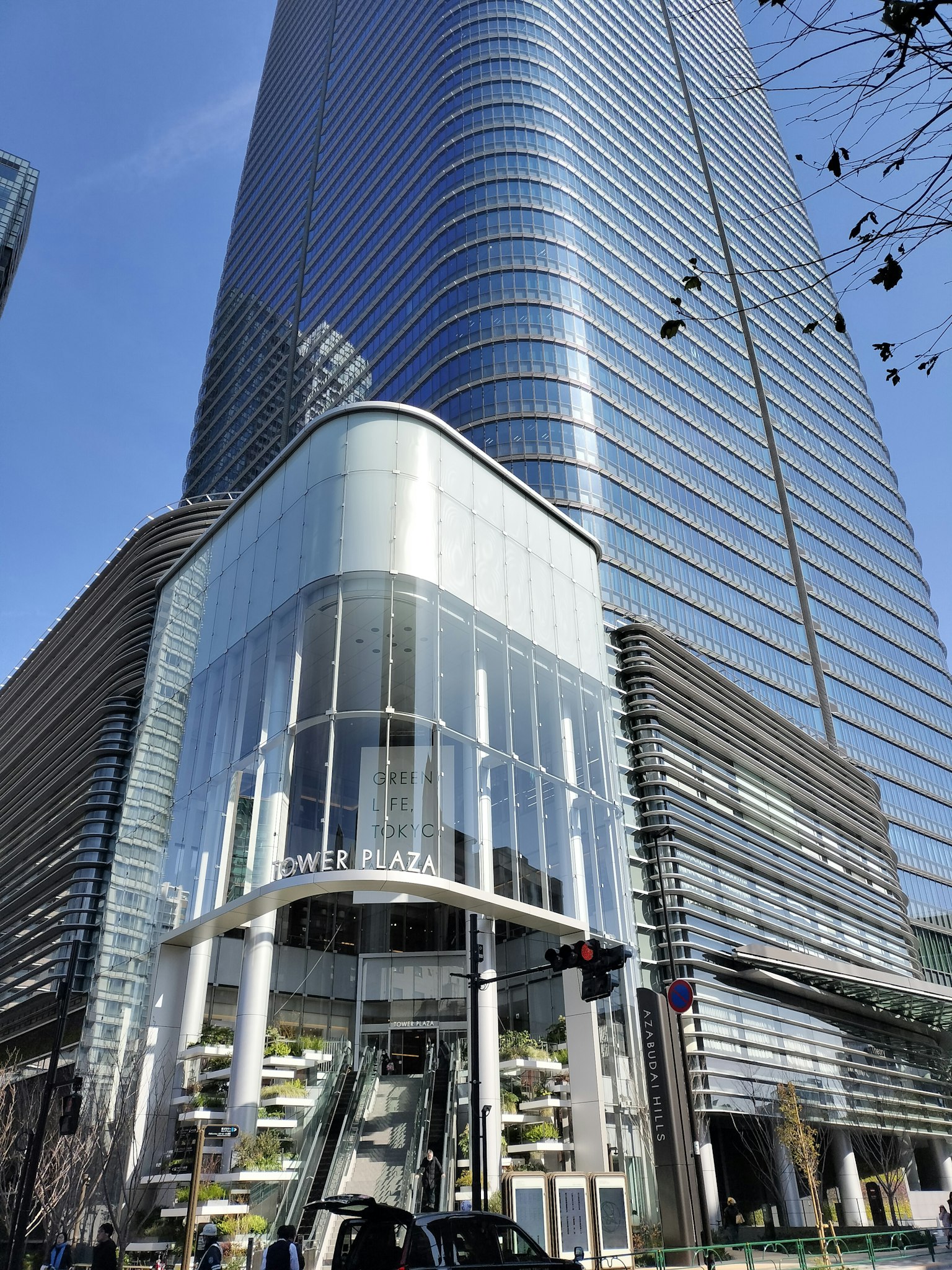 Close-up of a skyscraper with a glass facade and entrance