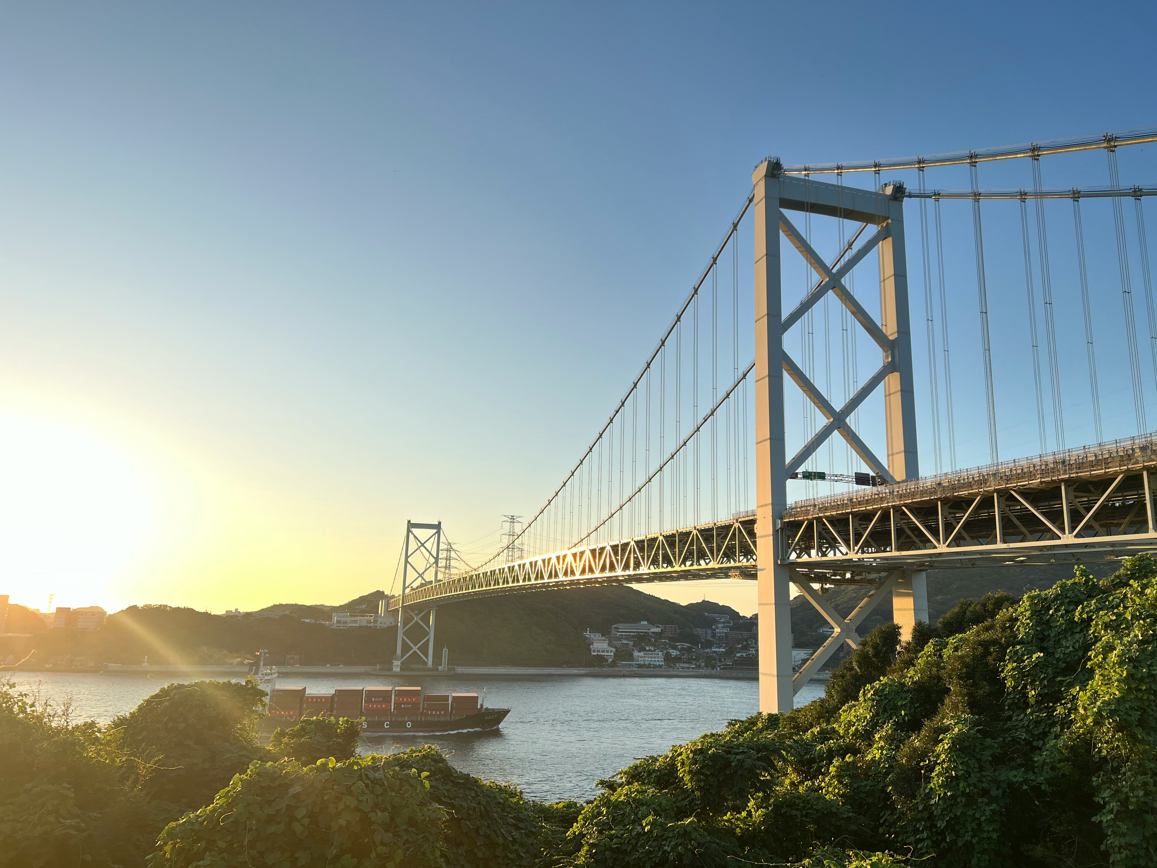 View of a suspension bridge over Kanmon Strait at dusk