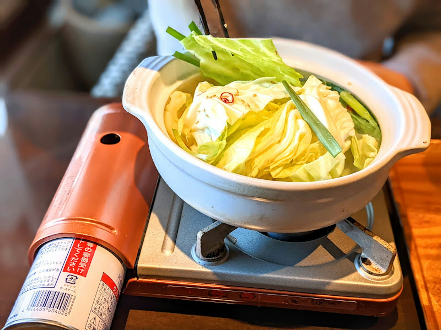 A warm pot dish with cabbage and vegetables placed on a table