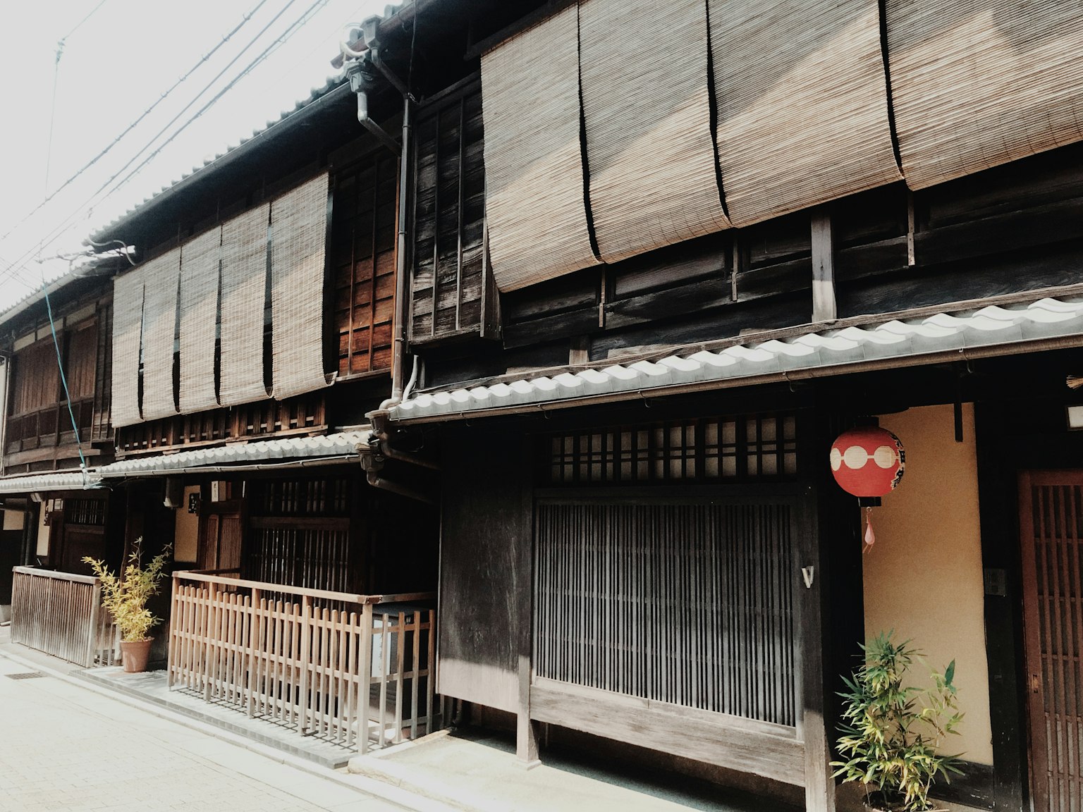 Traditional Japanese building exterior with wooden walls and bamboo blinds