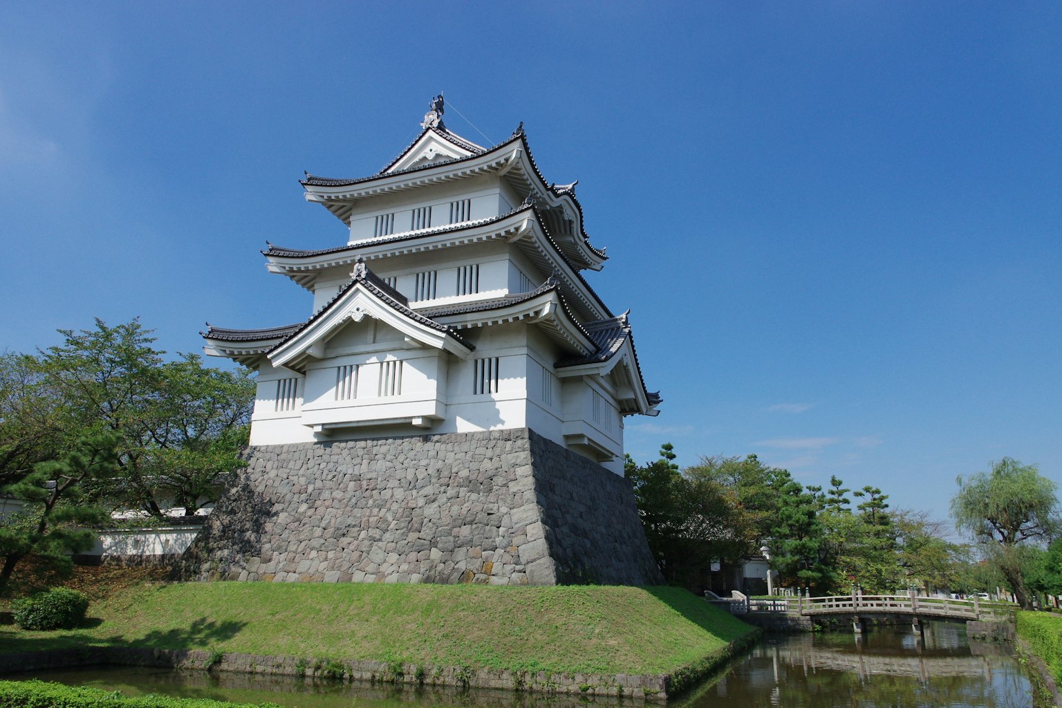 Traditional Japanese castle structure under a beautiful blue sky