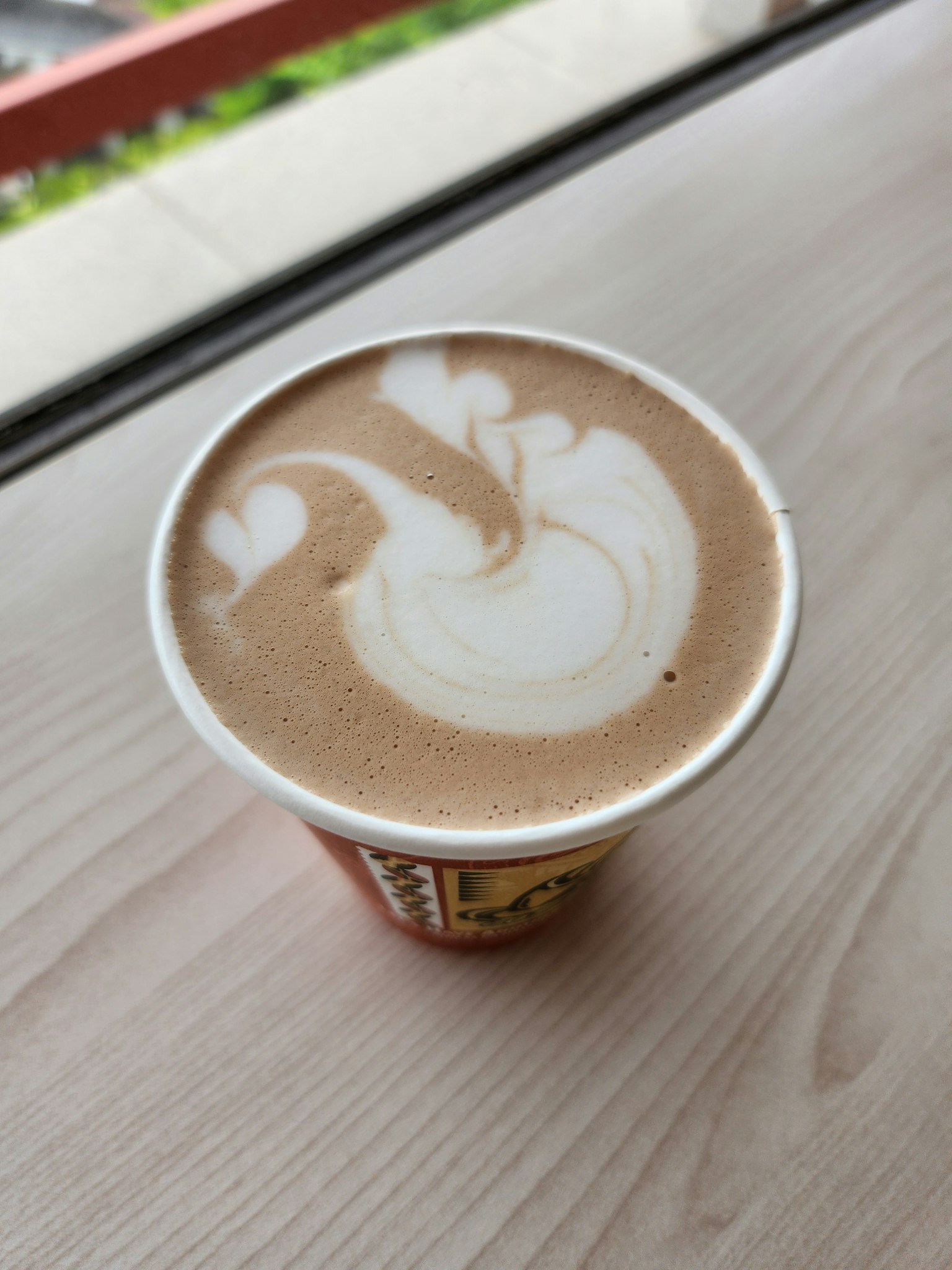 Latte art design on top of a coffee cup