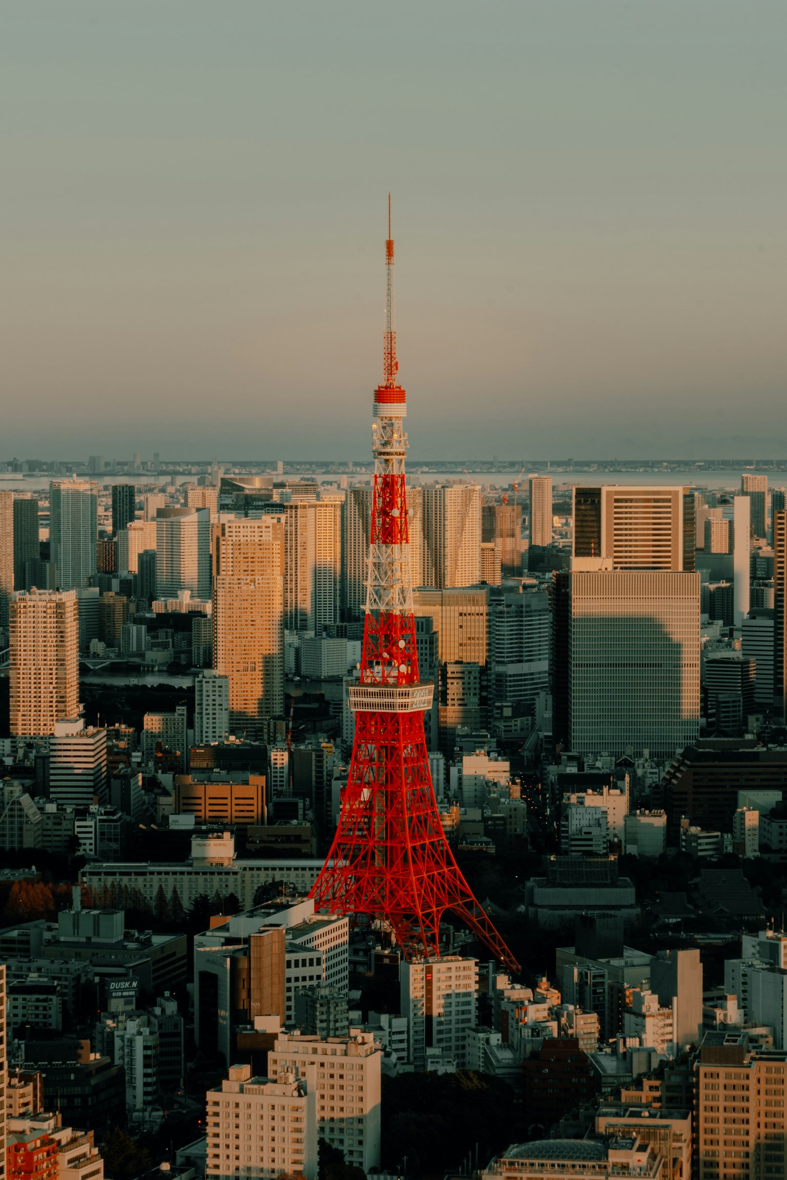 Tokyo Tower rising against the sunset skyline of the city